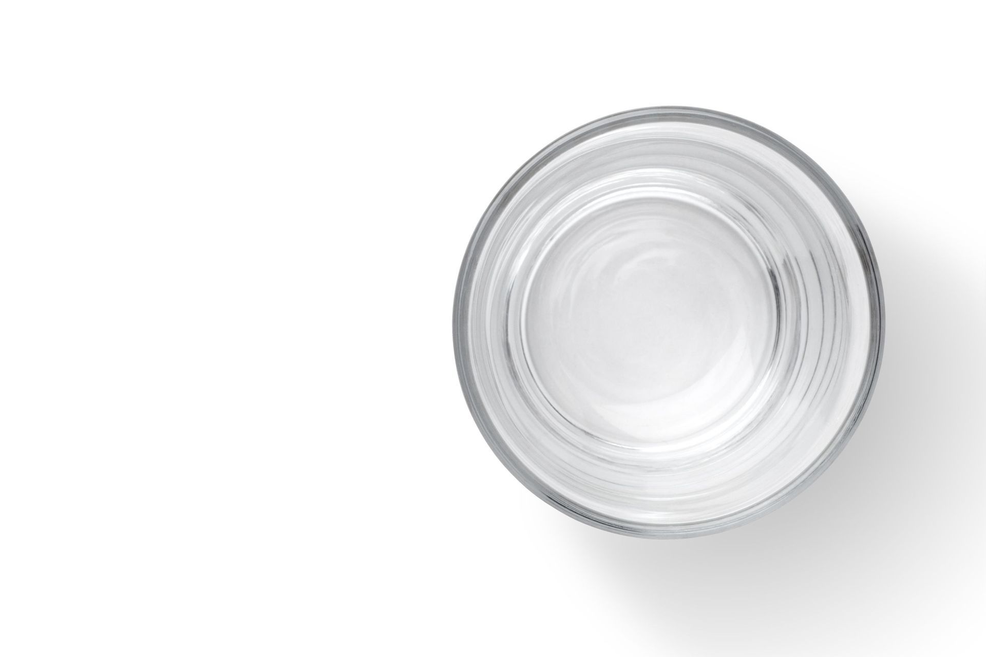 an empty glass of water on a white background