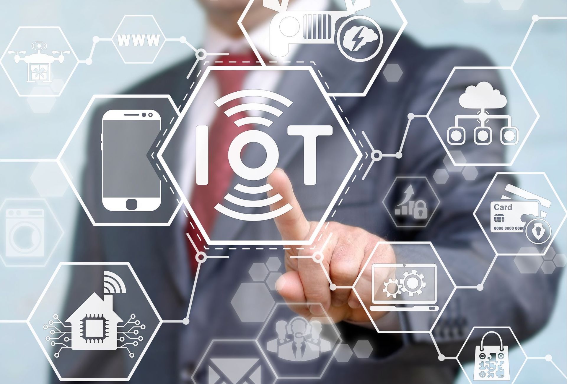 a man pressing a button on a screen that says iot