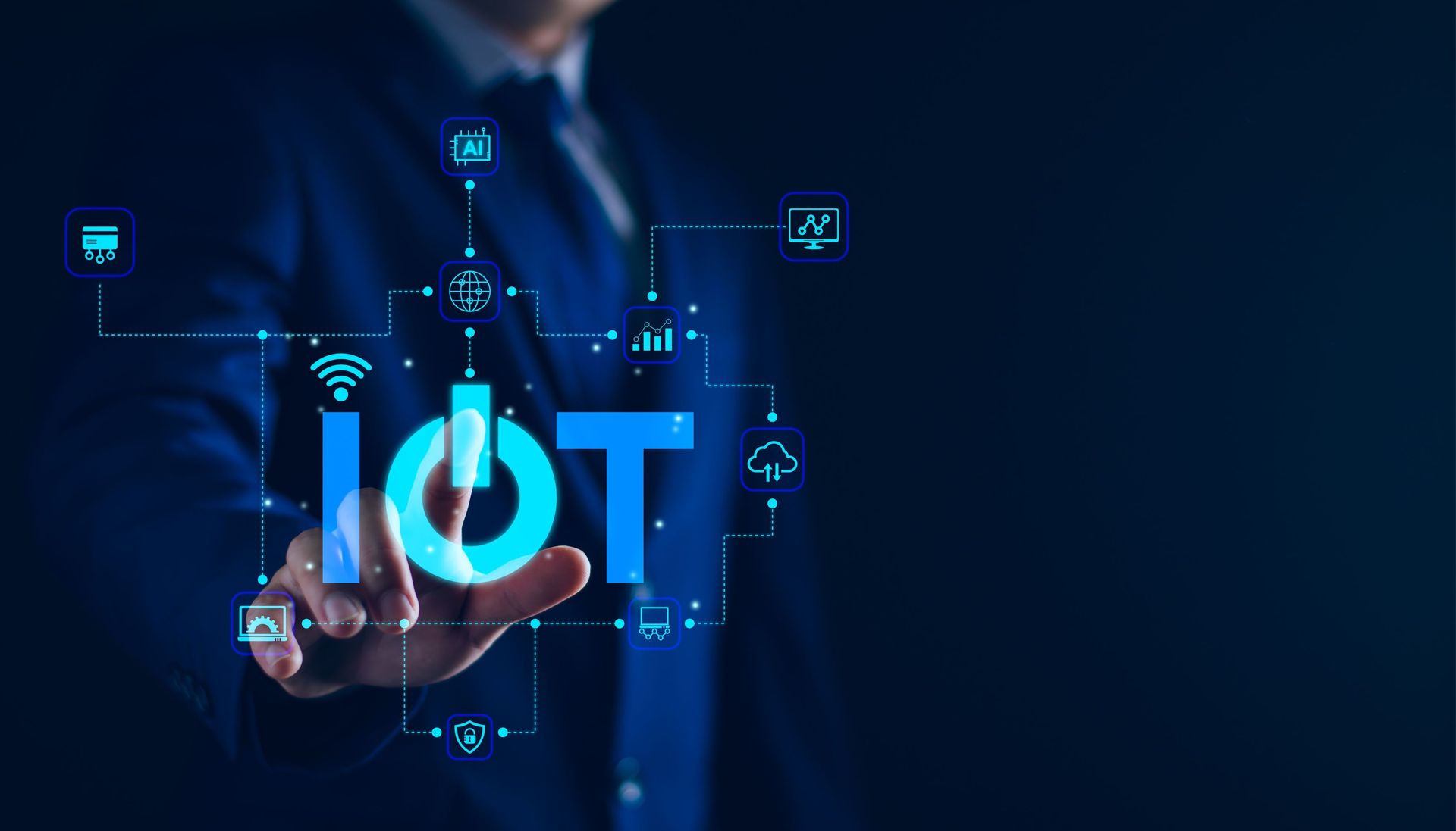 a man in a suit is pressing a button that says iot