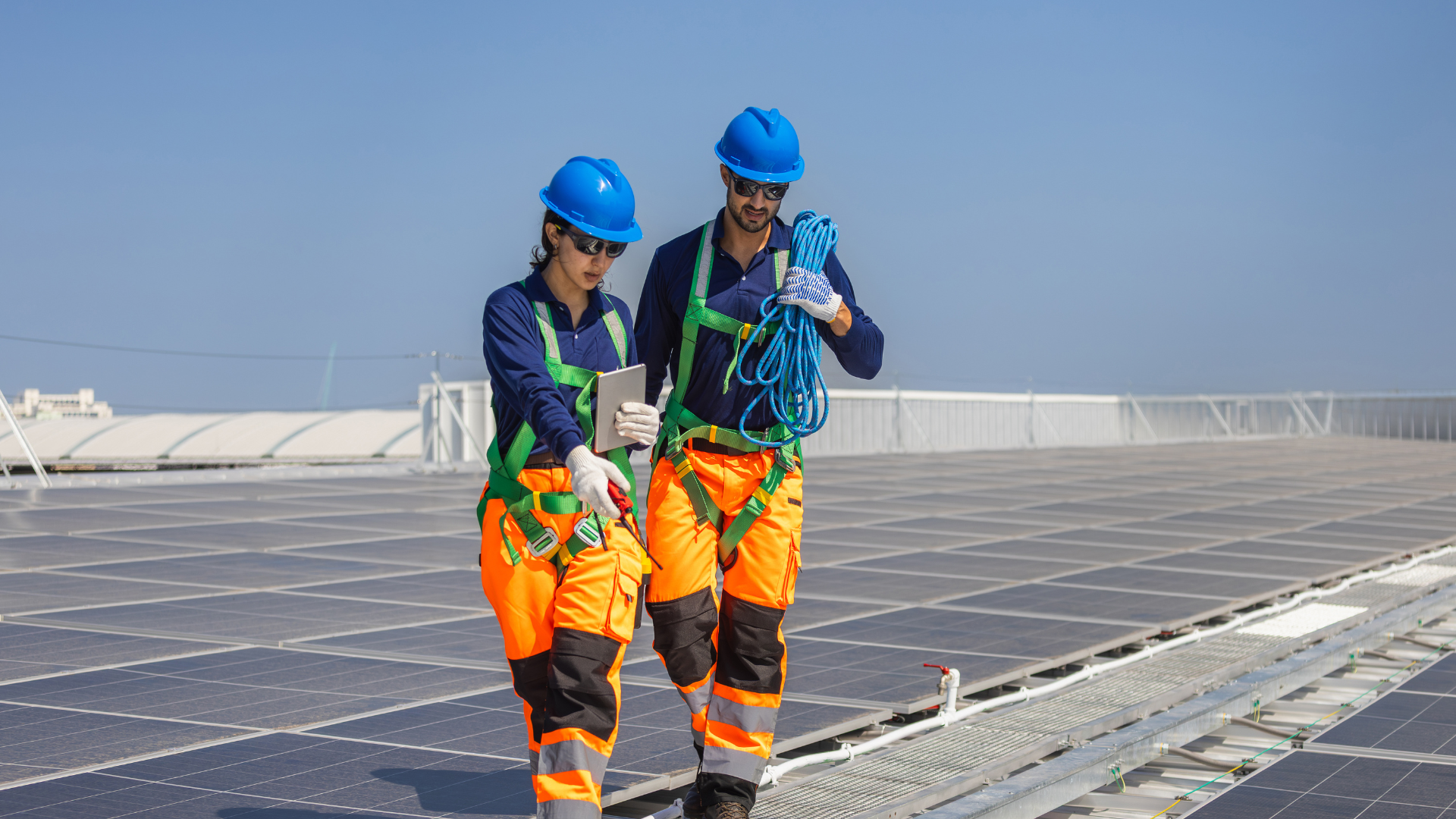 Sunbase solar rollout ad with worker installing panels and orange planning, prep, pilot, perform icons