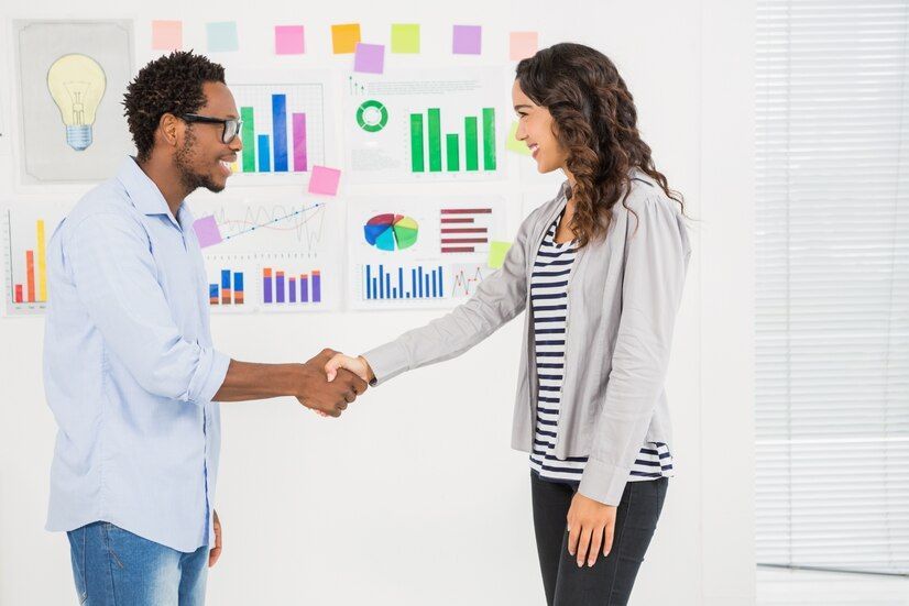 Young business people shaking hands