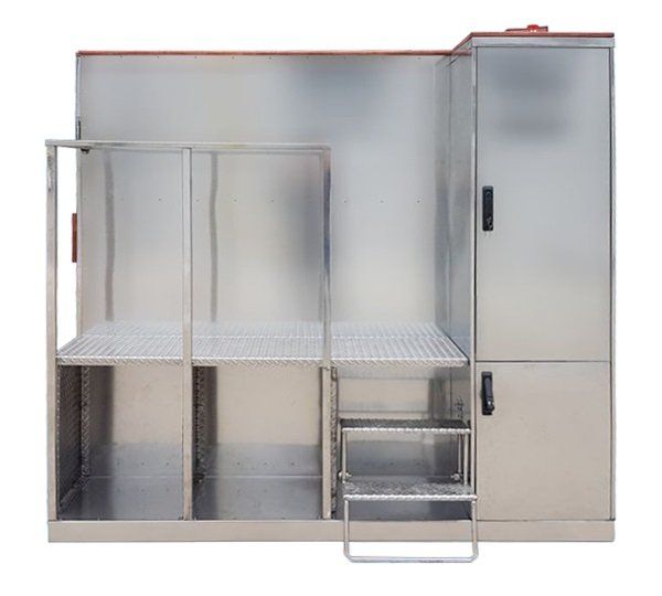 A stainless steel crypchamber with stairs leading up to it