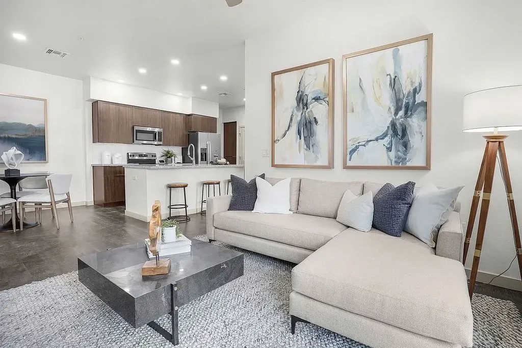 Living room with sectional sofa and artwork at The Landing at Fiesta Village in mesa, AZ.