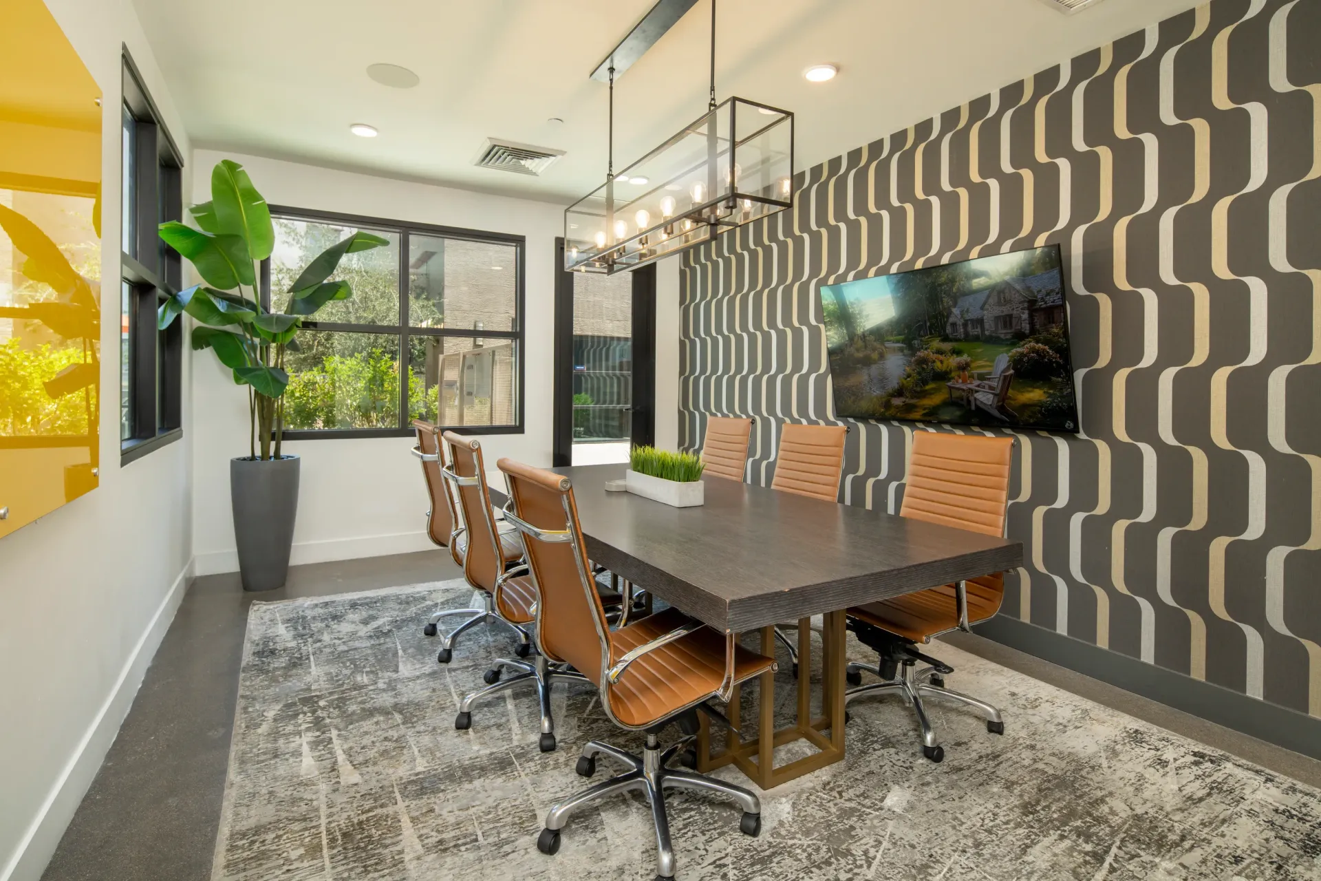 Modern conference room with a large table, executive chairs, and a flat-screen TV at The Landing at Fiesta Village in mesa, AZ.
