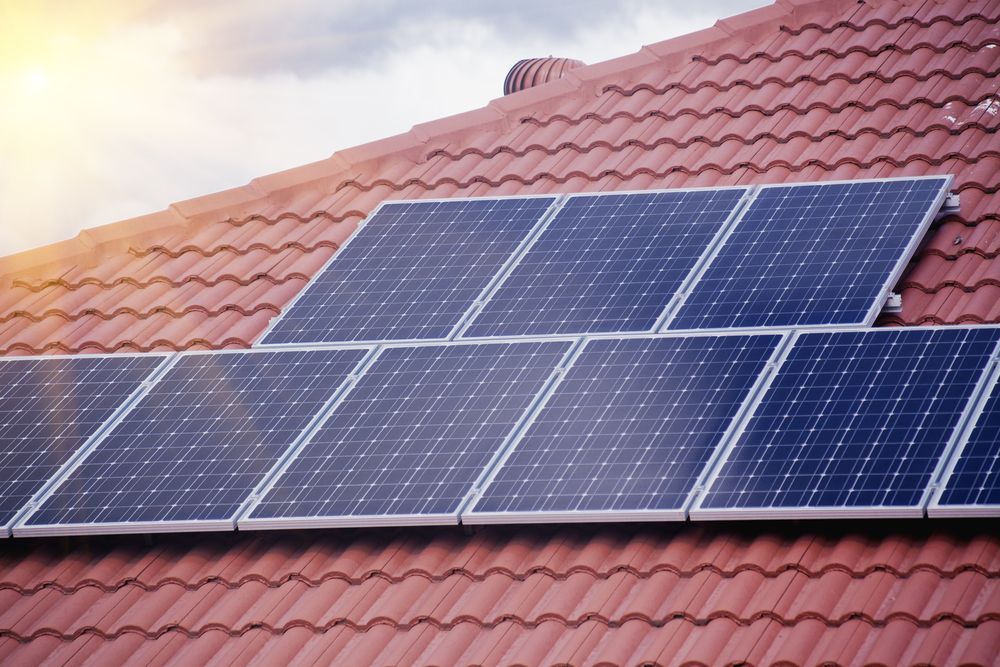 Solar Panels on a Red Tile Roof, Angled Toward the Sun — NTR Electrical In Maryborough, QLD