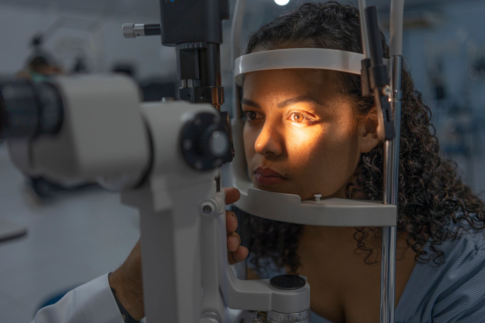 A woman is getting her eyes examined by an ophthalmologist.