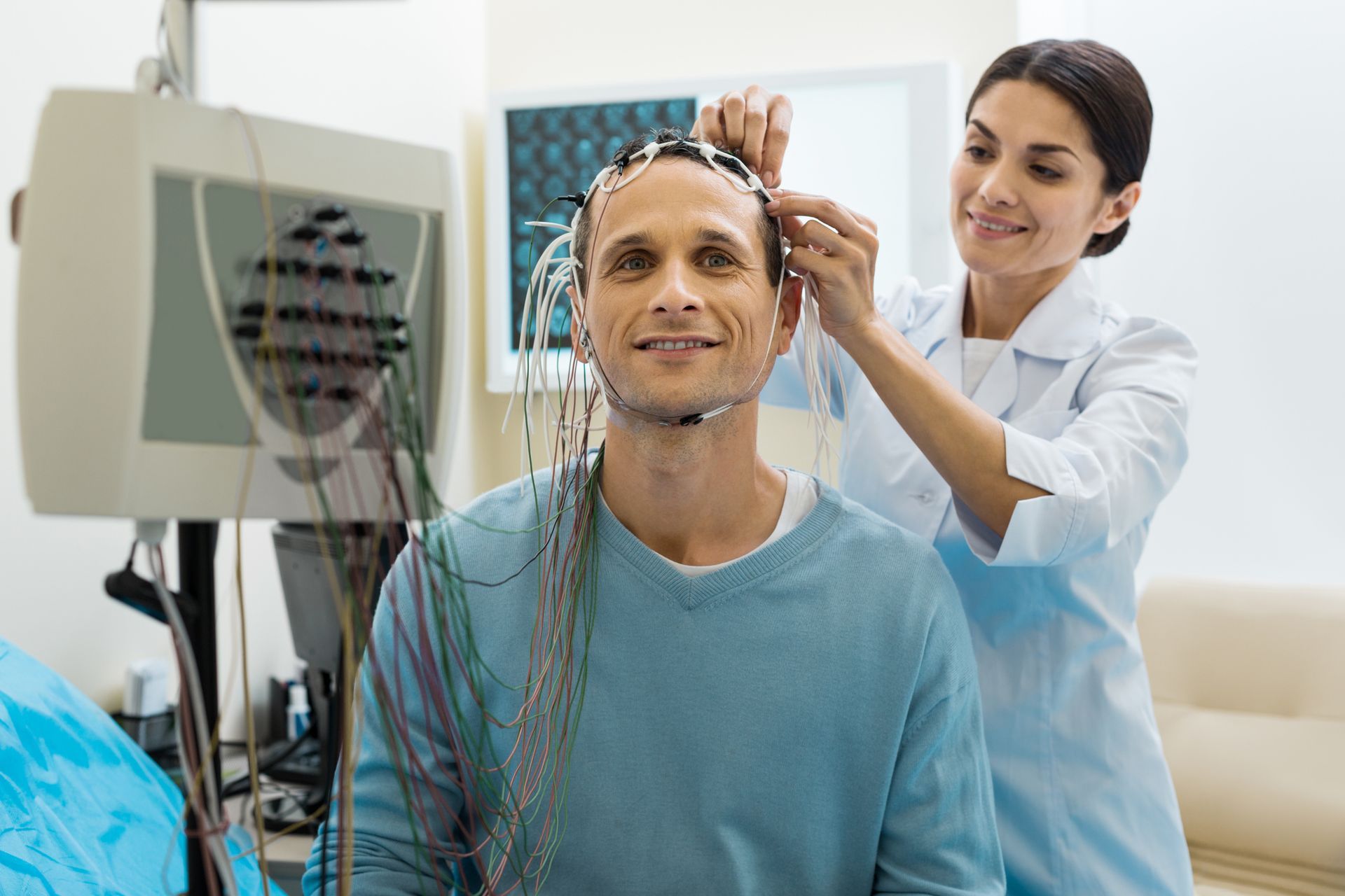 A man is getting an electroencephalogram in a hospital.