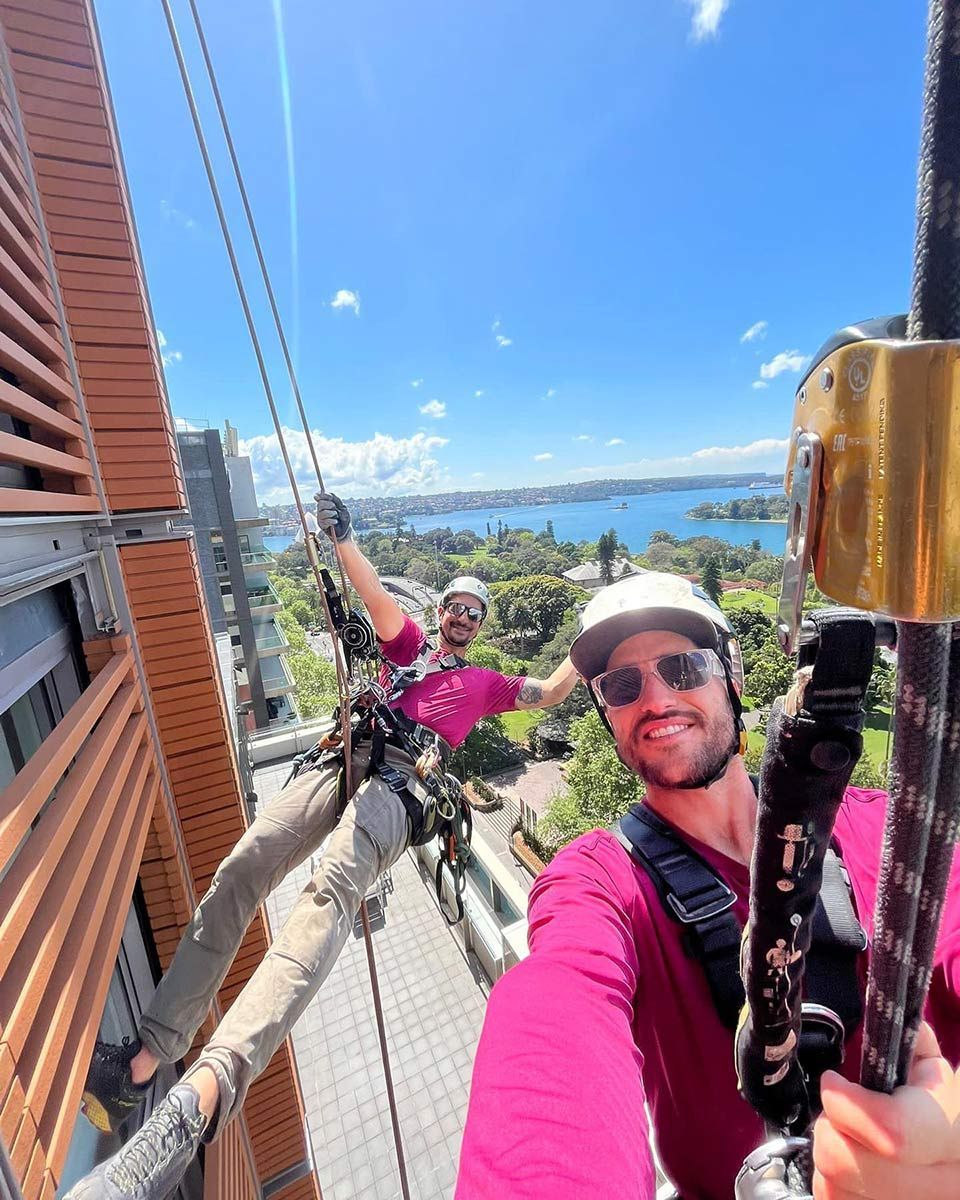Two Men Are Taking A Selfie On Top Of A Building — Freshwater Exterior Cleaning in Lennox Head, NSW
