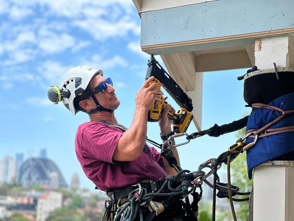 An Man Fixing A Gutter on A Harness — Freshwater Exterior Cleaning in Lennox Head, NSW