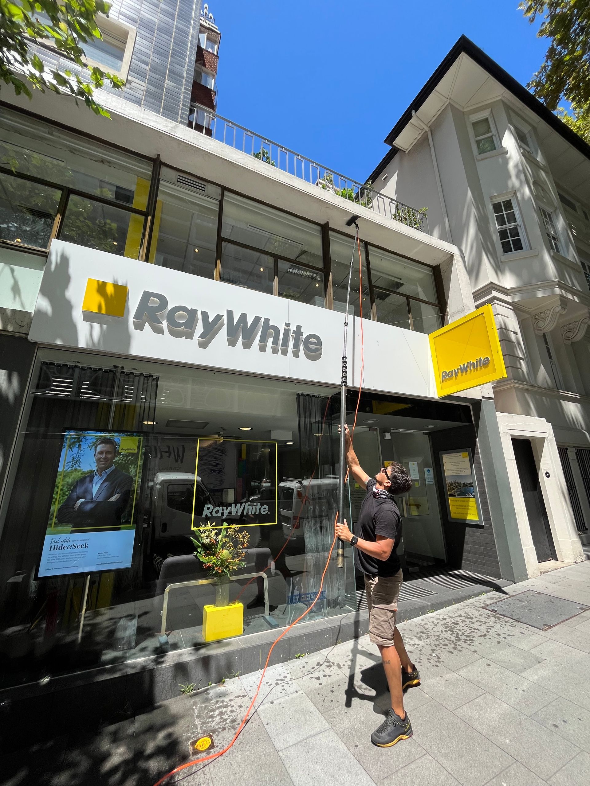 Man Cleaning The Exterior of Ray White Building — Freshwater Exterior Cleaning in Ballina, NSW