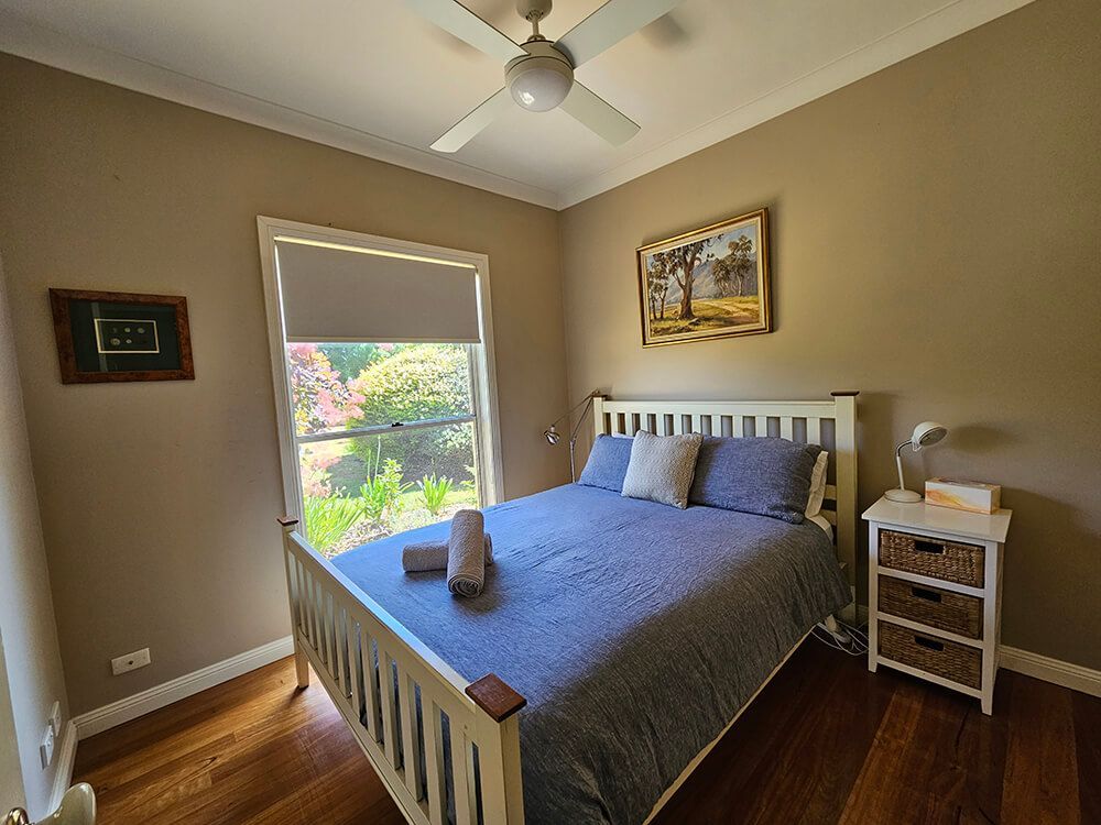 A Bedroom With A Bed And A Painting On The Wall — A Perfect Move And Clean In Welby NSW 