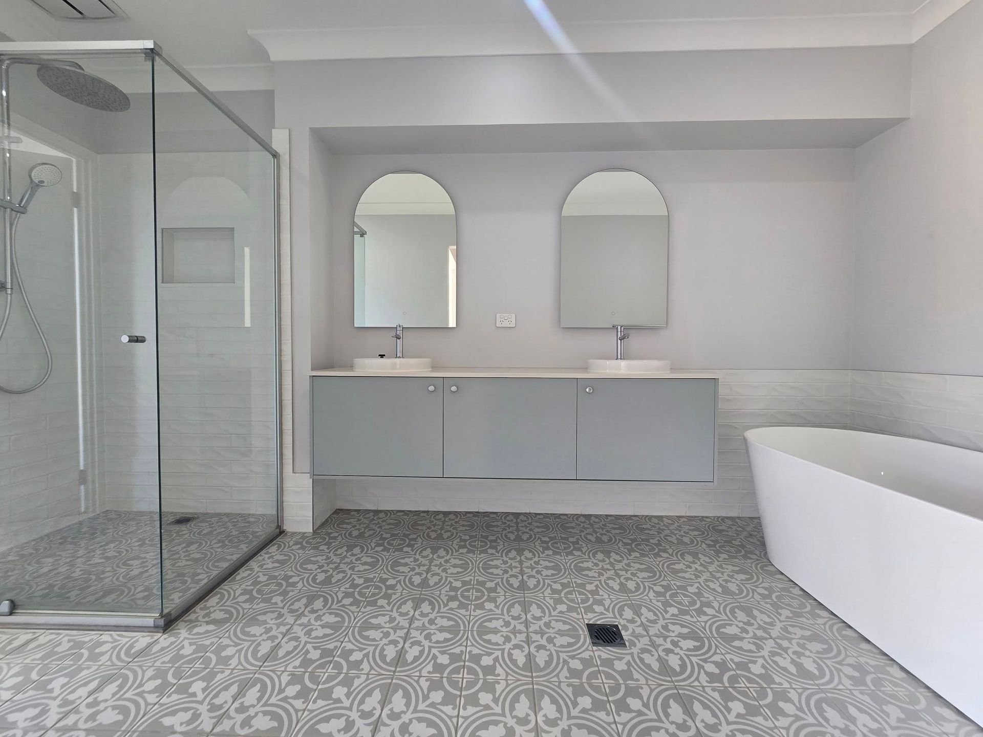 Bathroom with Bathtub Having Square Tiles and Open door — A Perfect Move And Clean In Mittagong NSW