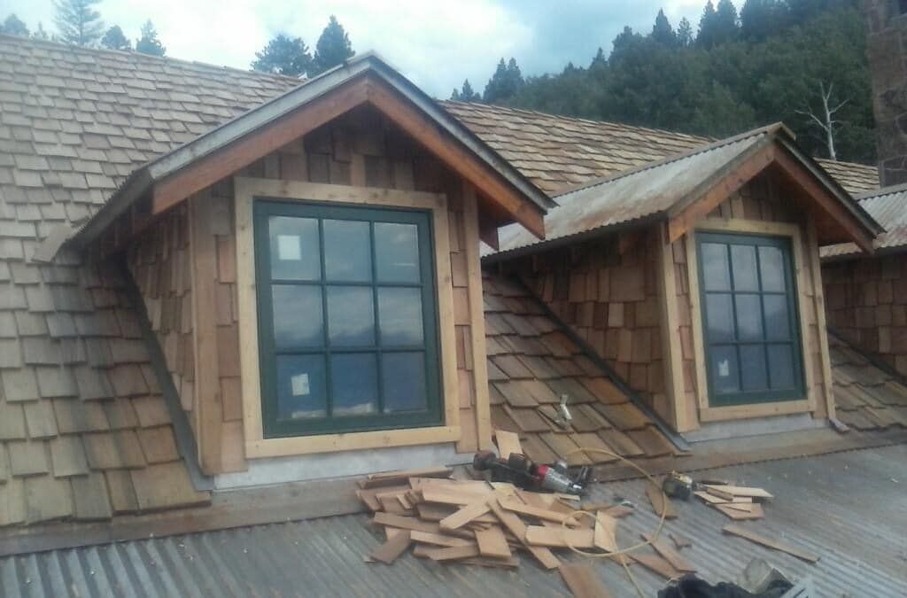 A house with a roof that has two windows on it