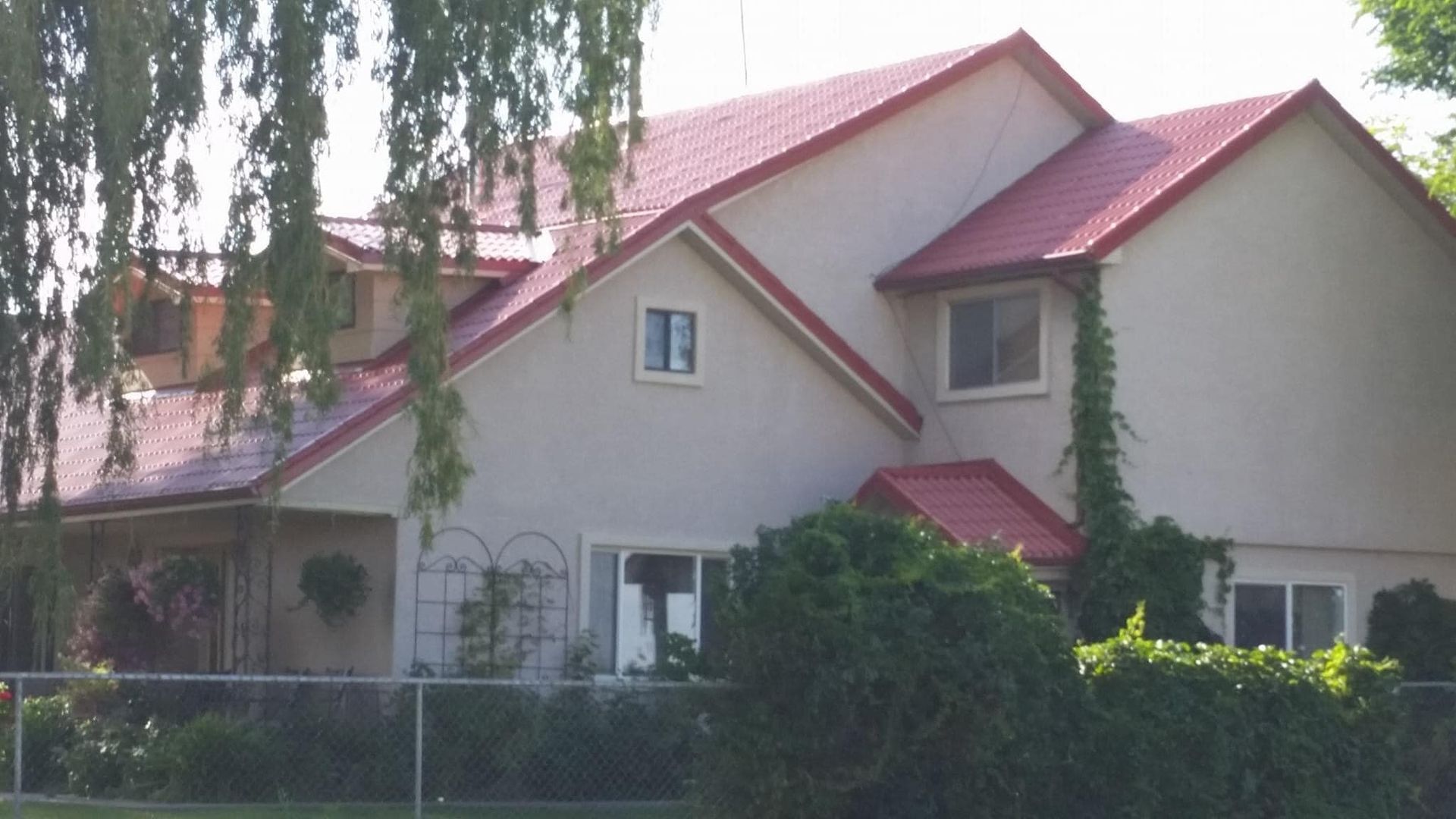 A large white house with a red roof