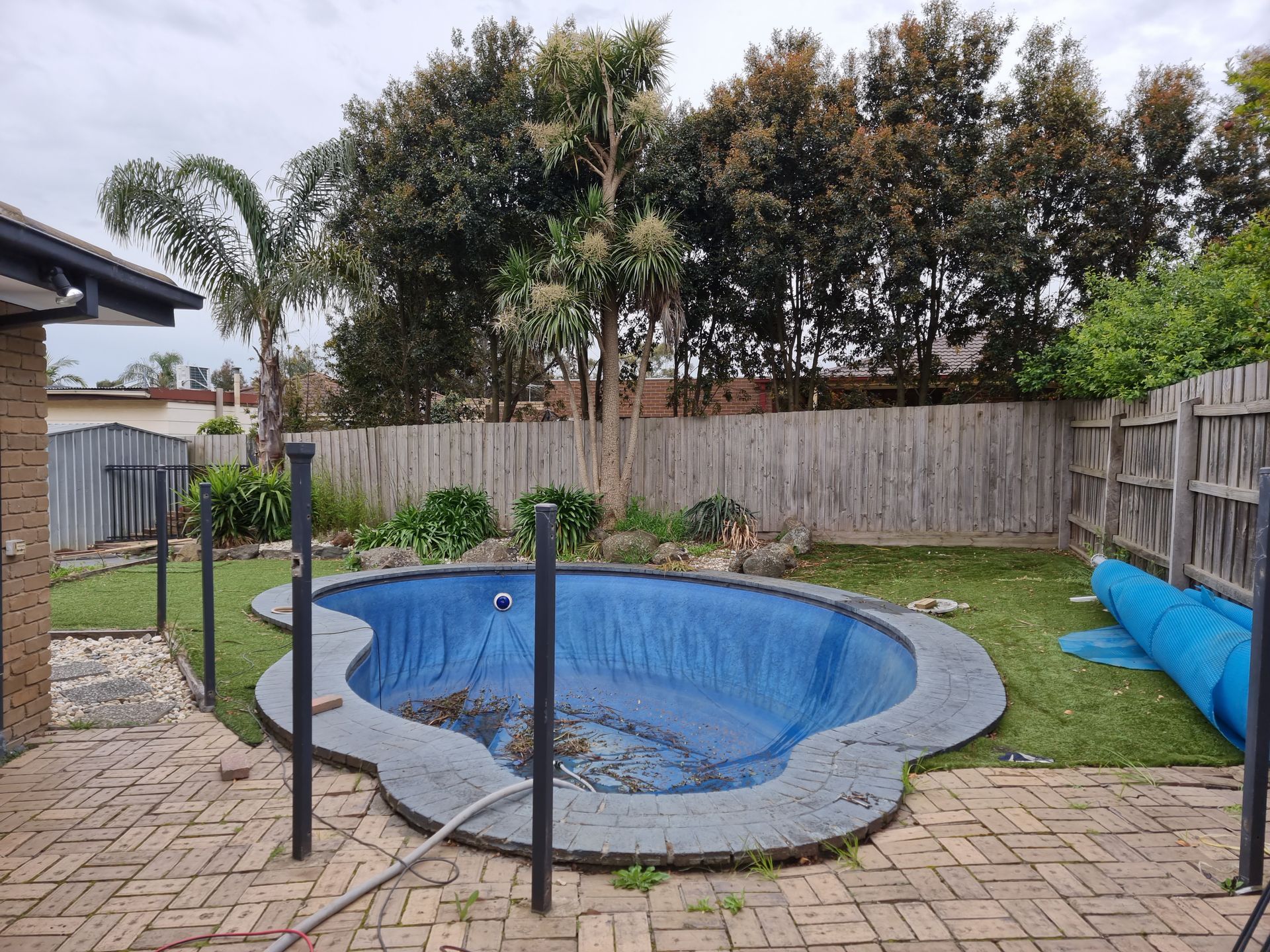 A Small, Blue-lined Kidney-shaped Swimming Pool in a Backyard — All Over Pool Removals in Doncaster, VIC