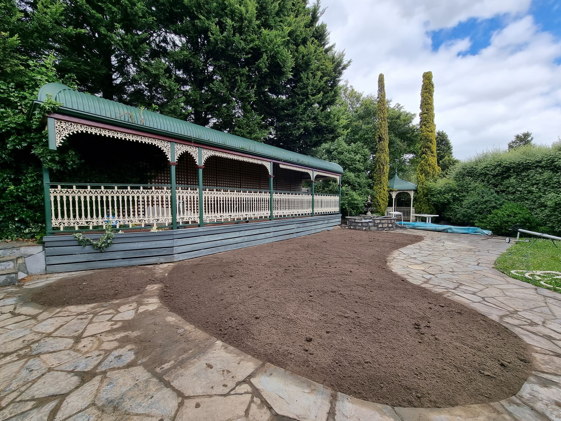 A Covered Pavilion With a White Fence and Decorative Trim Sits — All Over Pool Removals in Chadstone, VIC