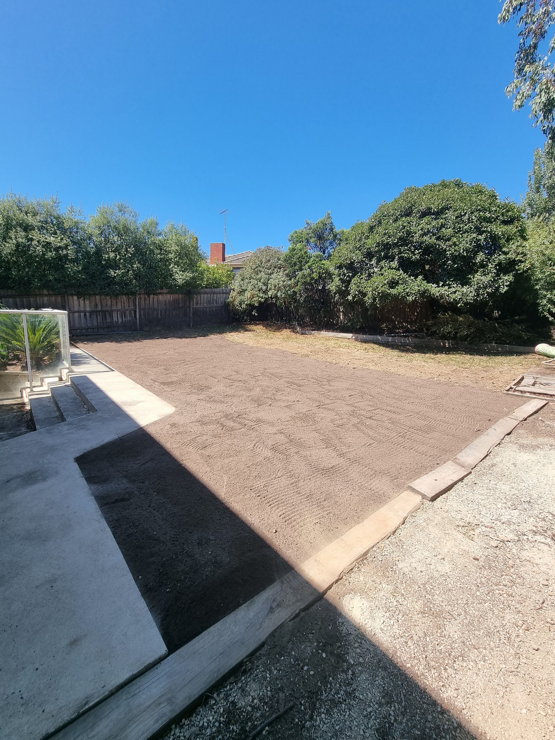 A Backyard View Featuring a Large, Dirt-covered Ground Area, Paved Walkway — All Over Pool Removals in Donvale, VIC