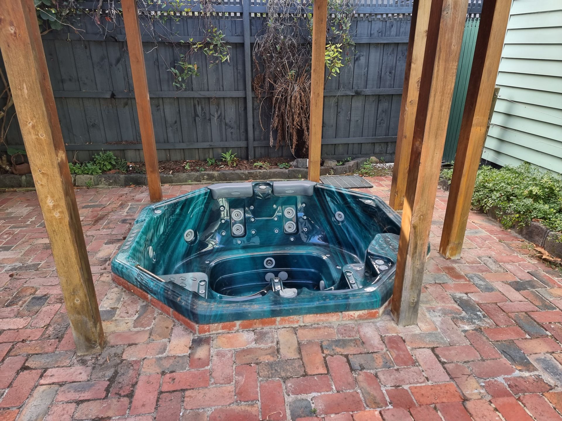 A Deep Teal, Hexagonal Hot Tub Recessed Into a Red Brick Patio — All Over Pool Removals in Lilydale, VIC