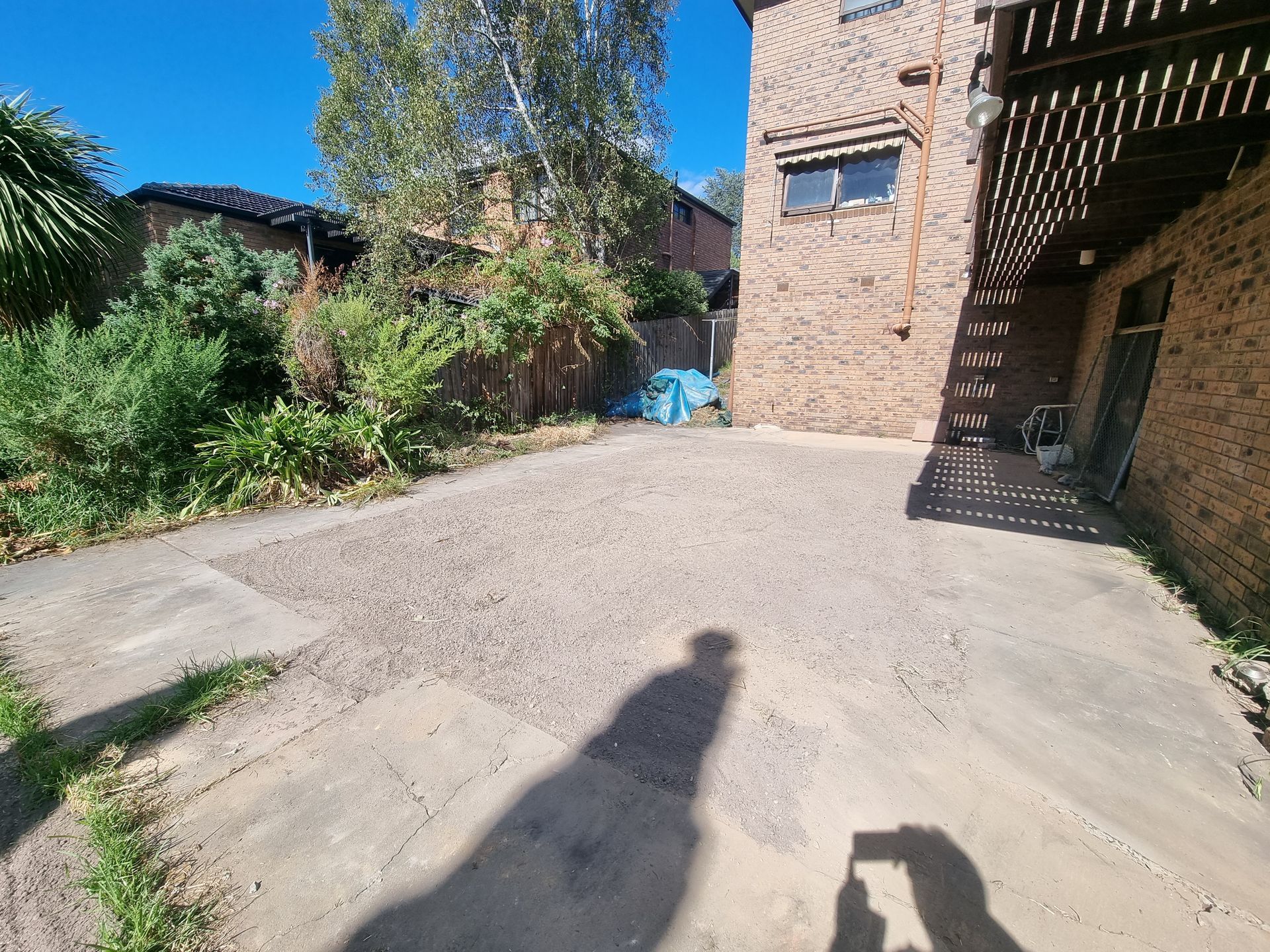 A paved outdoor area with a central gravel section — All Over Pool Removals in Doncaster, VIC