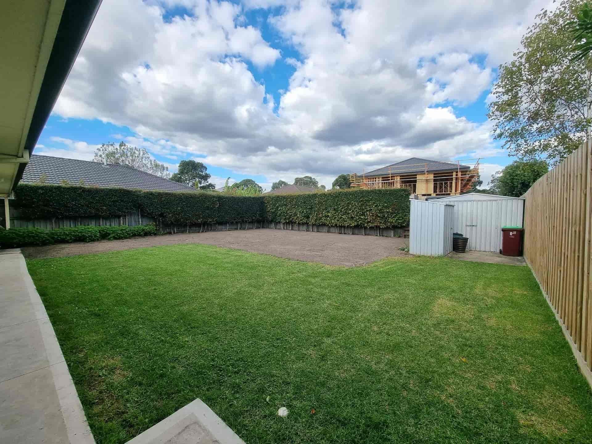 Green Backyard With Grass, a Hedge, and a Partly Cloudy Sky — All Over Pool Removals in Beaumaris, VIC