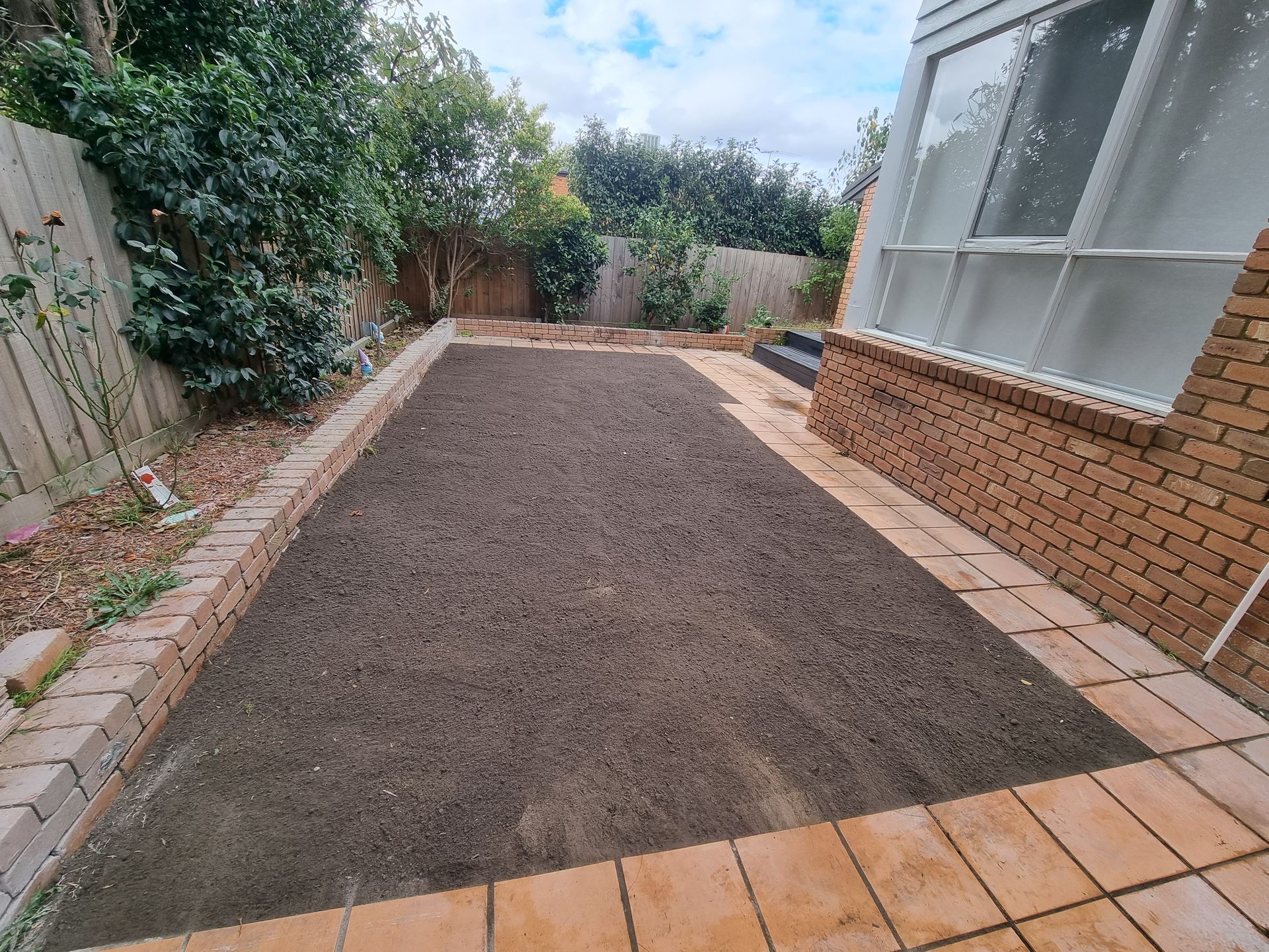 A Freshly Prepared Rectangular Garden Bed With Dark Soil, Bordered — All Over Pool Removals in Surrey Hills, VIC