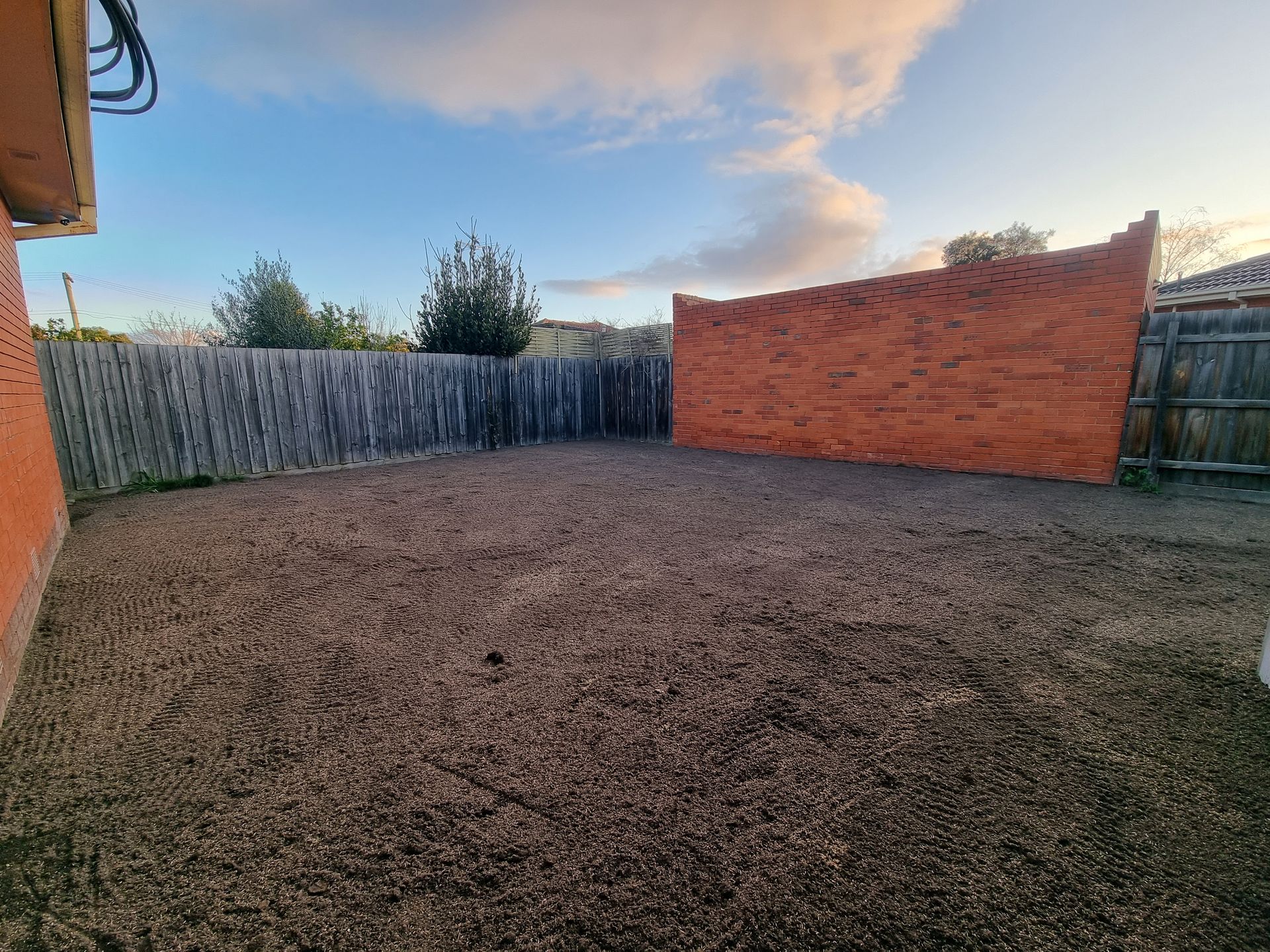 A Fenced Backyard With a Ground-level Gravel Surface and a Decorative Reddish-brown — All Over Pool Removals in Donvale, VIC