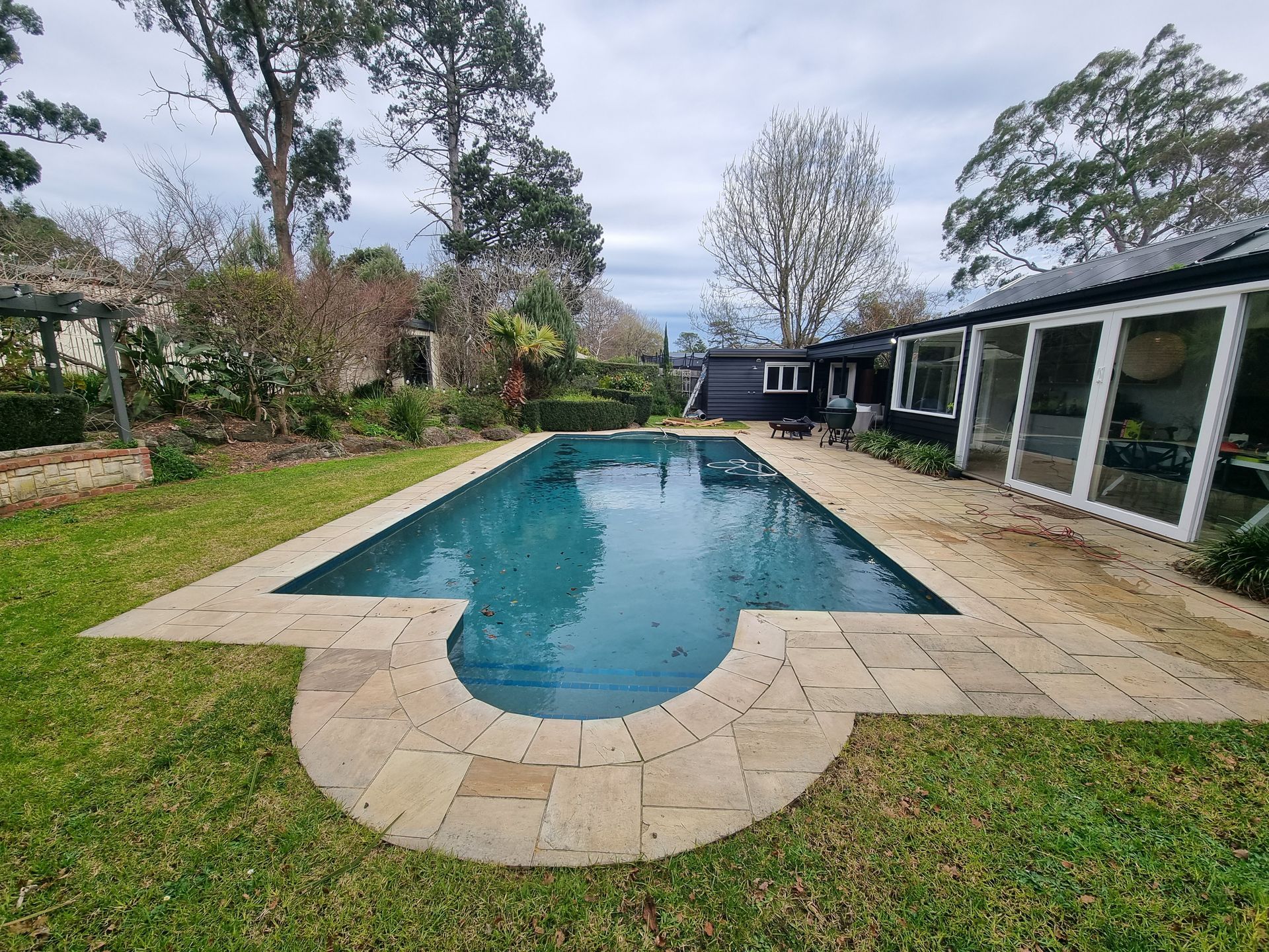 Backyard Swimming Pool With Stone Patio — All Over Pool Removals in Upwey, VIC
