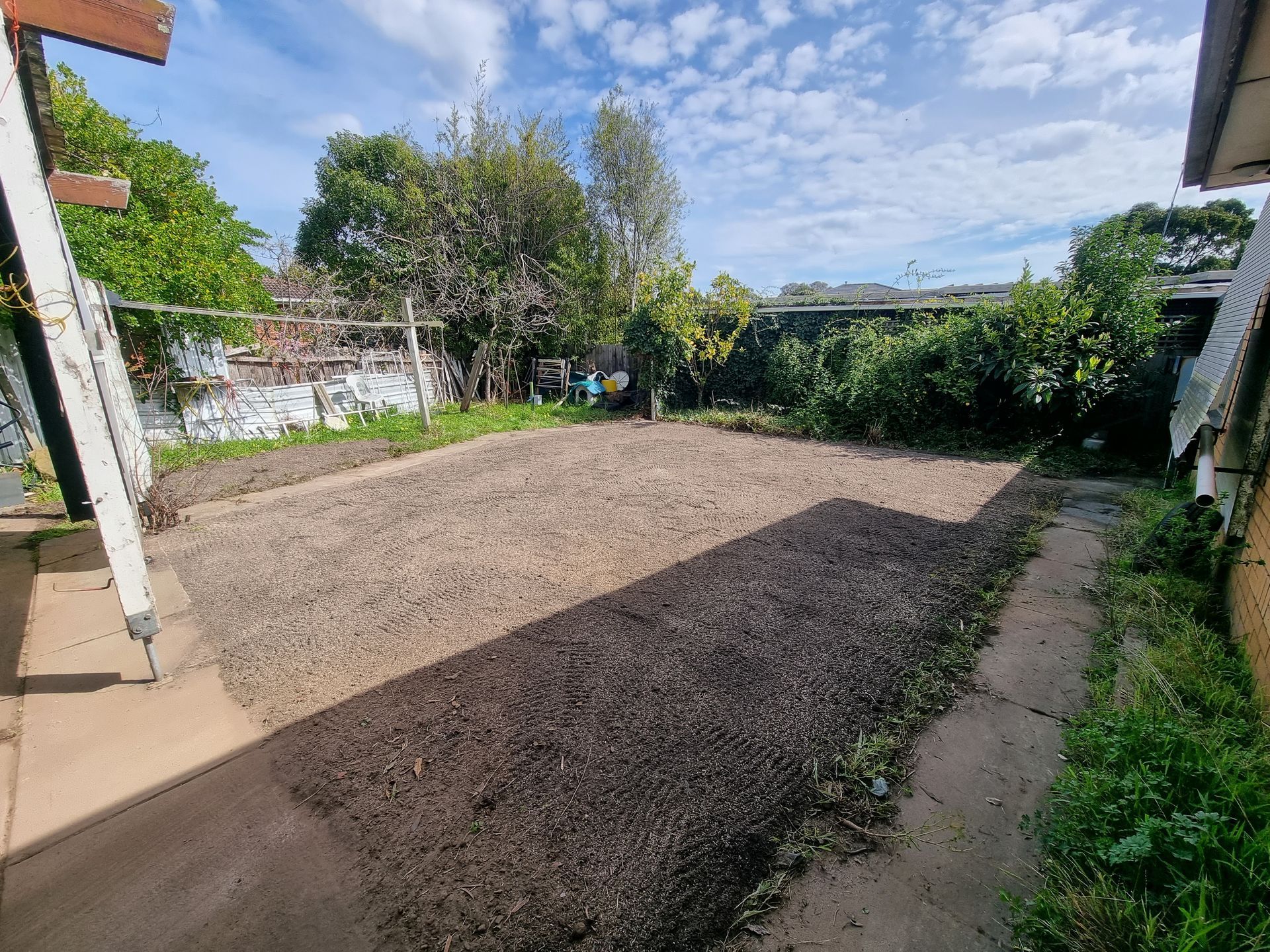 A Backyard Area Featuring a Rectangular Dirt Patch Surrounded by Mulch — All Over Pool Removals in Glen Waverley, VIC