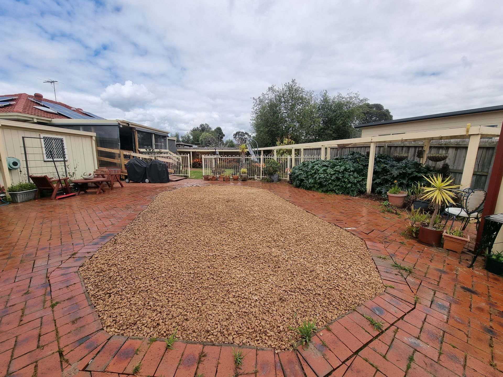 A Brick-paved Backyard Featuring a Large Central Patch of Brown Gravel — All Over Pool Removals in Donvale, VIC