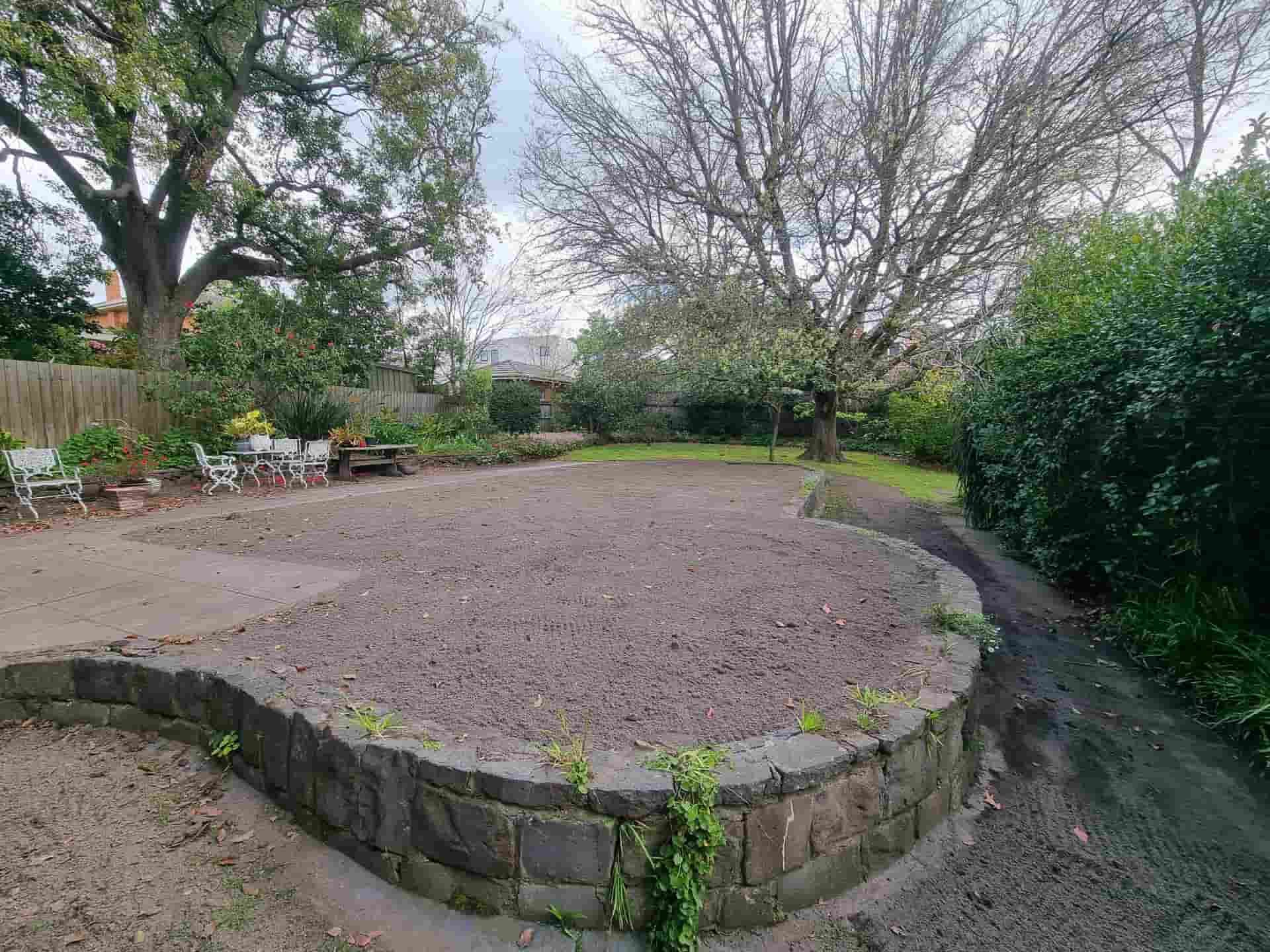 A Large Backyard With a Prepared Garden Bed, Surrounded by Stone Wall — All Over Pool Removals in Hawthorn, VIC
