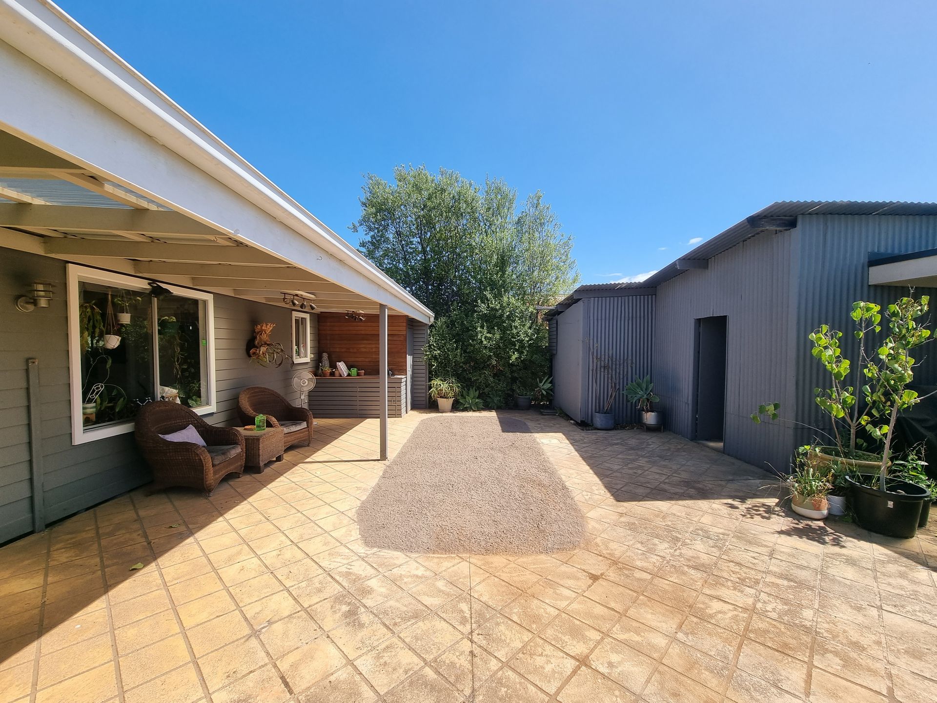 A Patio With Patterned Paving, Featuring a Covered Seating Area — All Over Pool Removals in Narre Warren South, VIC