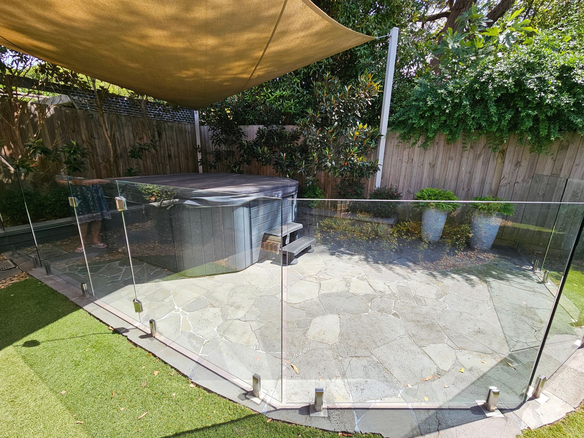 Glass Pool Fence Enclosing an Empty Backyard SPA — All Over Pool Removals in Templestowe, VIC