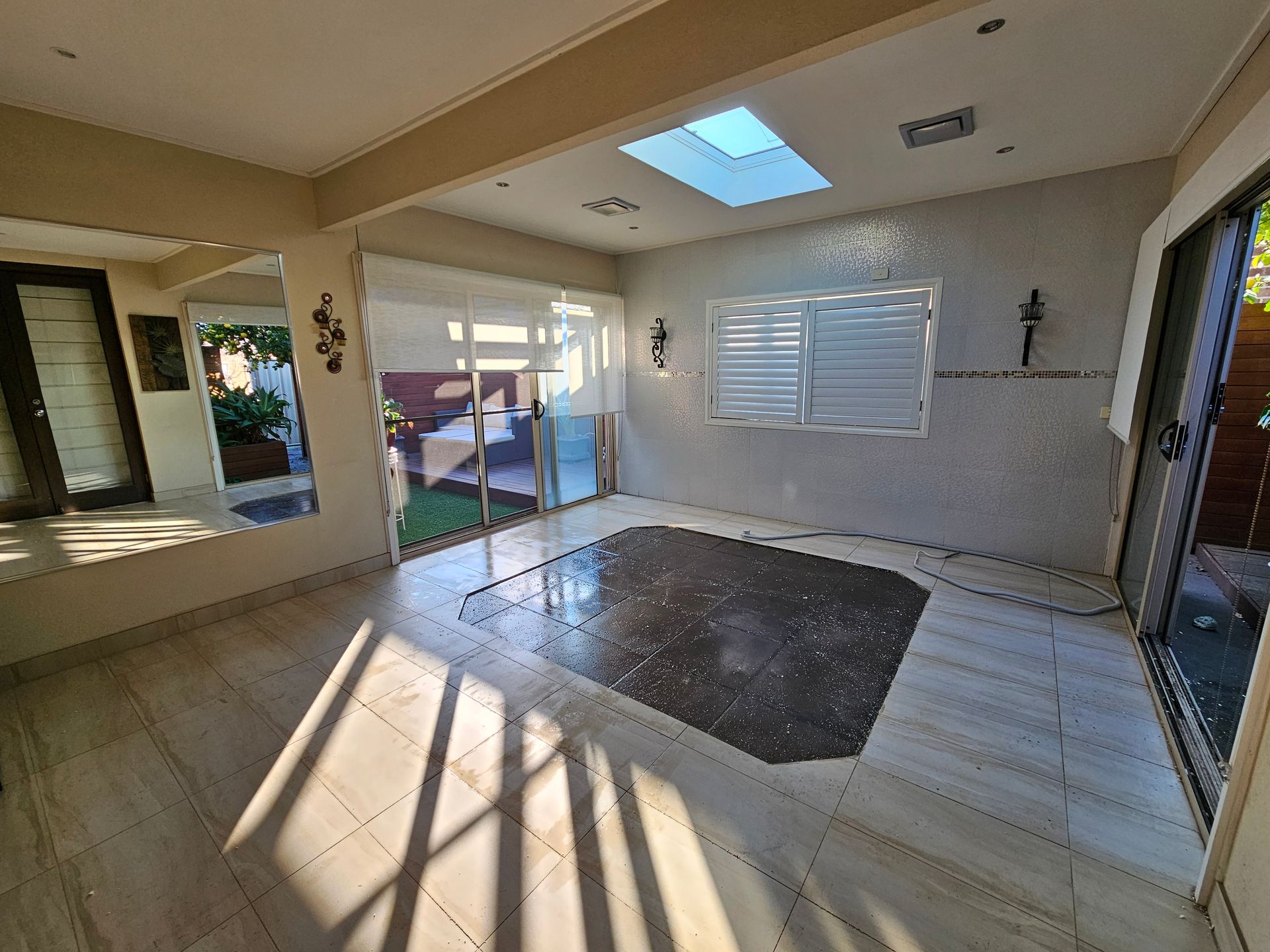 Sunlit Empty Living Room With Tile Floor, Skylight — All Over Pool Removals in Upwey, VIC