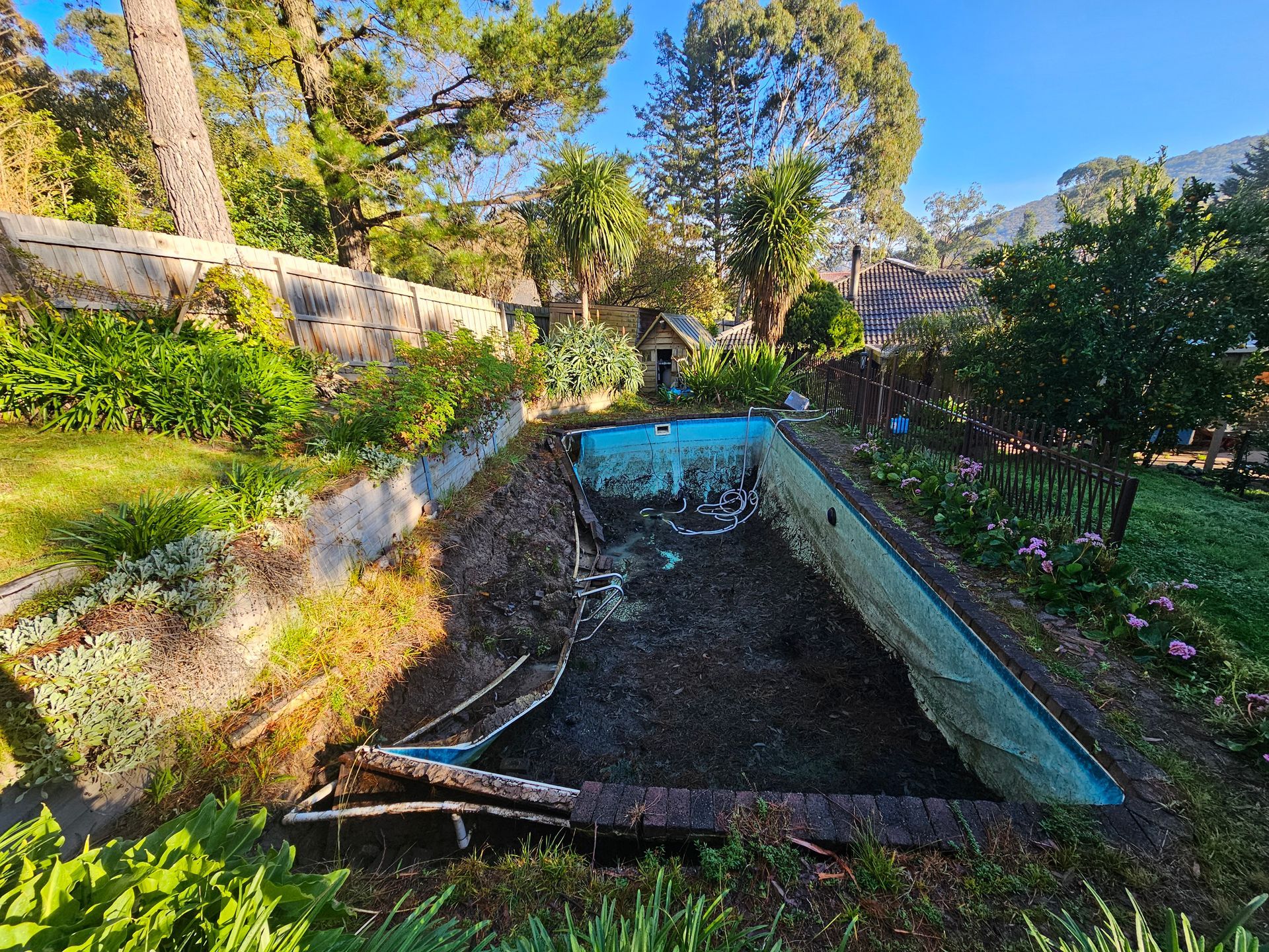 A Gravel-filled Courtyard Area Beside a Brick Building — All Over Pool Removals in Upwey, VIC