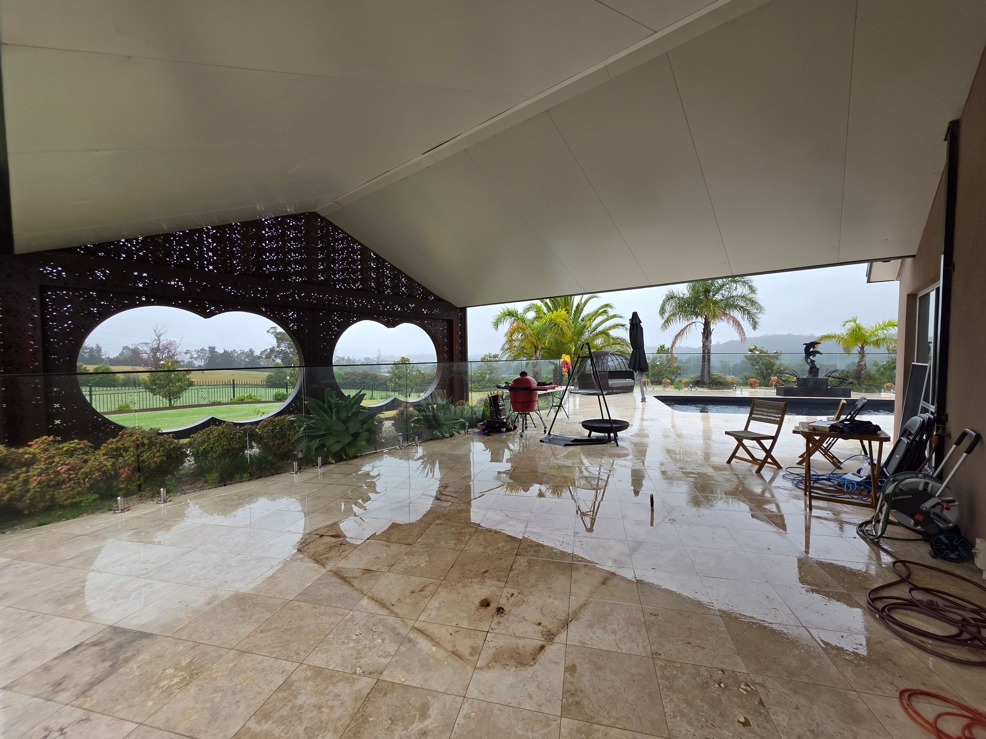 Covered Patio With Reflective Wet Floor, Lounge Chairs — All Over Pool Removals in Upwey, VIC