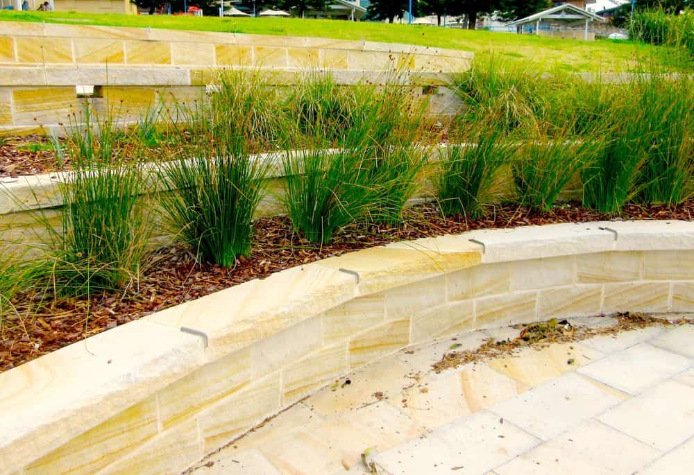 Stone Terraced Garden Bed With Green Grass and Mulch — All Over Pool Removals in Surrey Hills, VIC