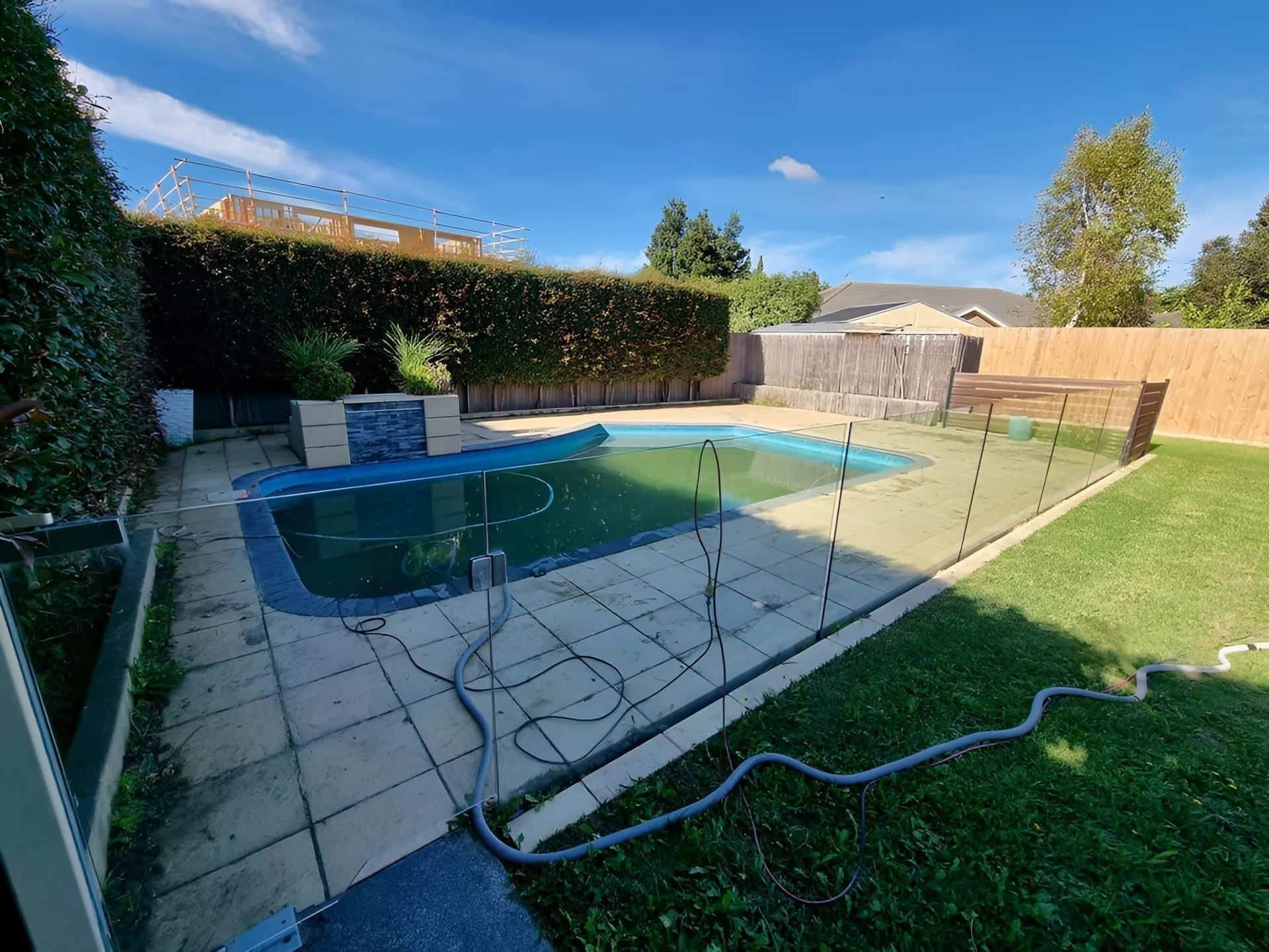 Backyard With Pool, Overgrown Hedge, Green Grass, Blue Sky — All Over Pool Removals in Upwey, VIC