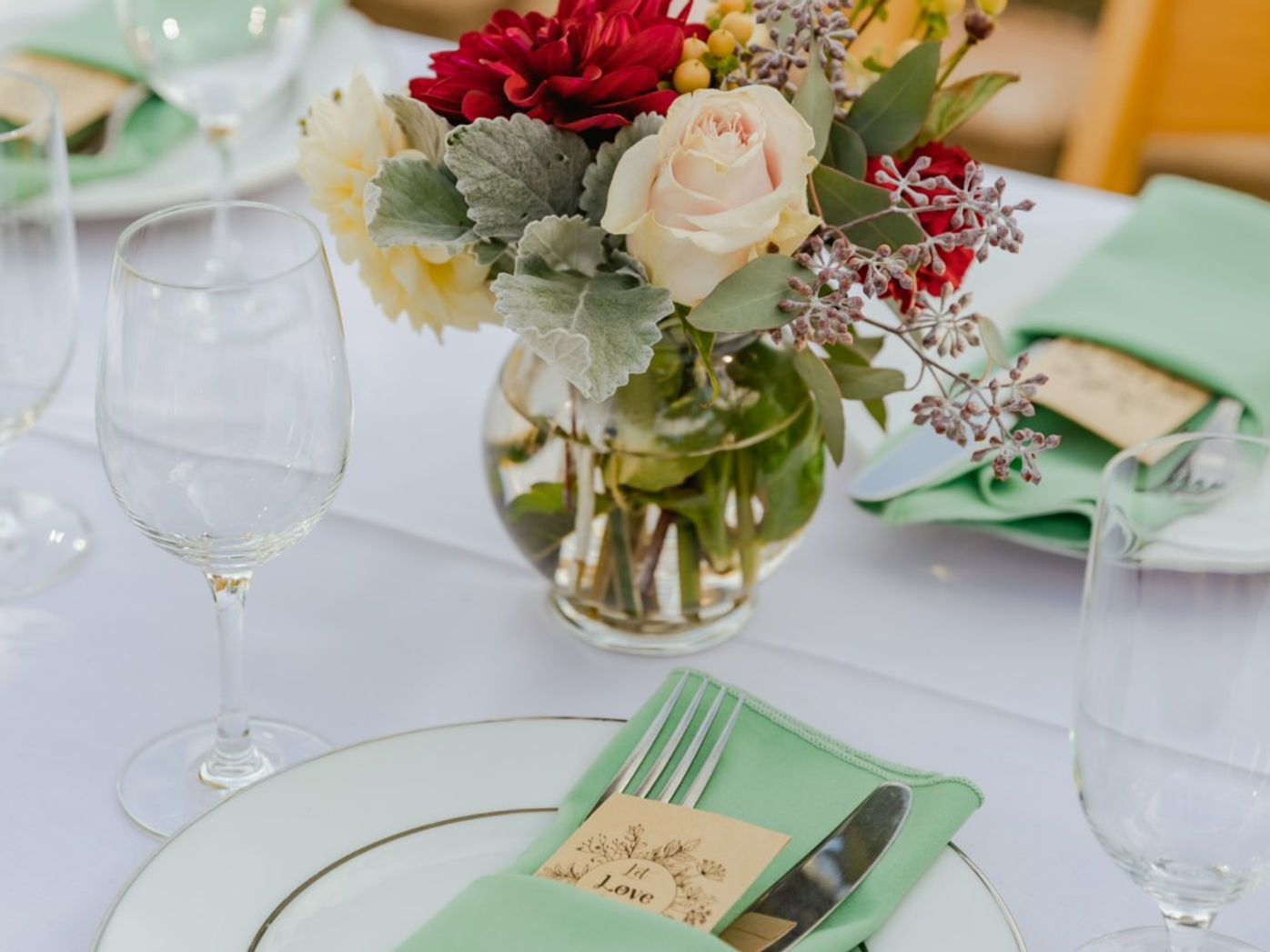 Table setting with floral centerpiece and place setting with napkin.