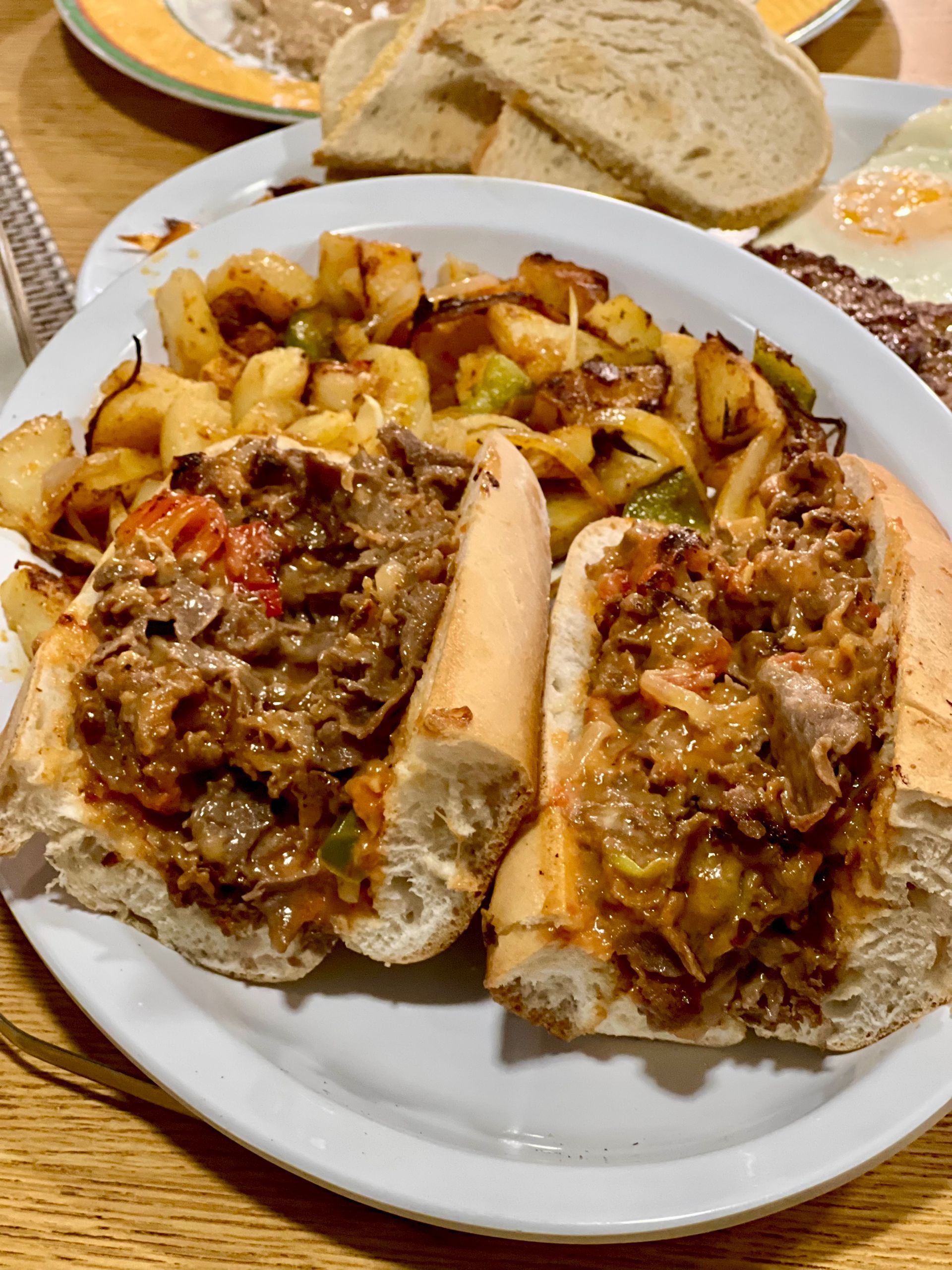 Plate of bread rolls filled with savory meat and potato mixture on a dining table