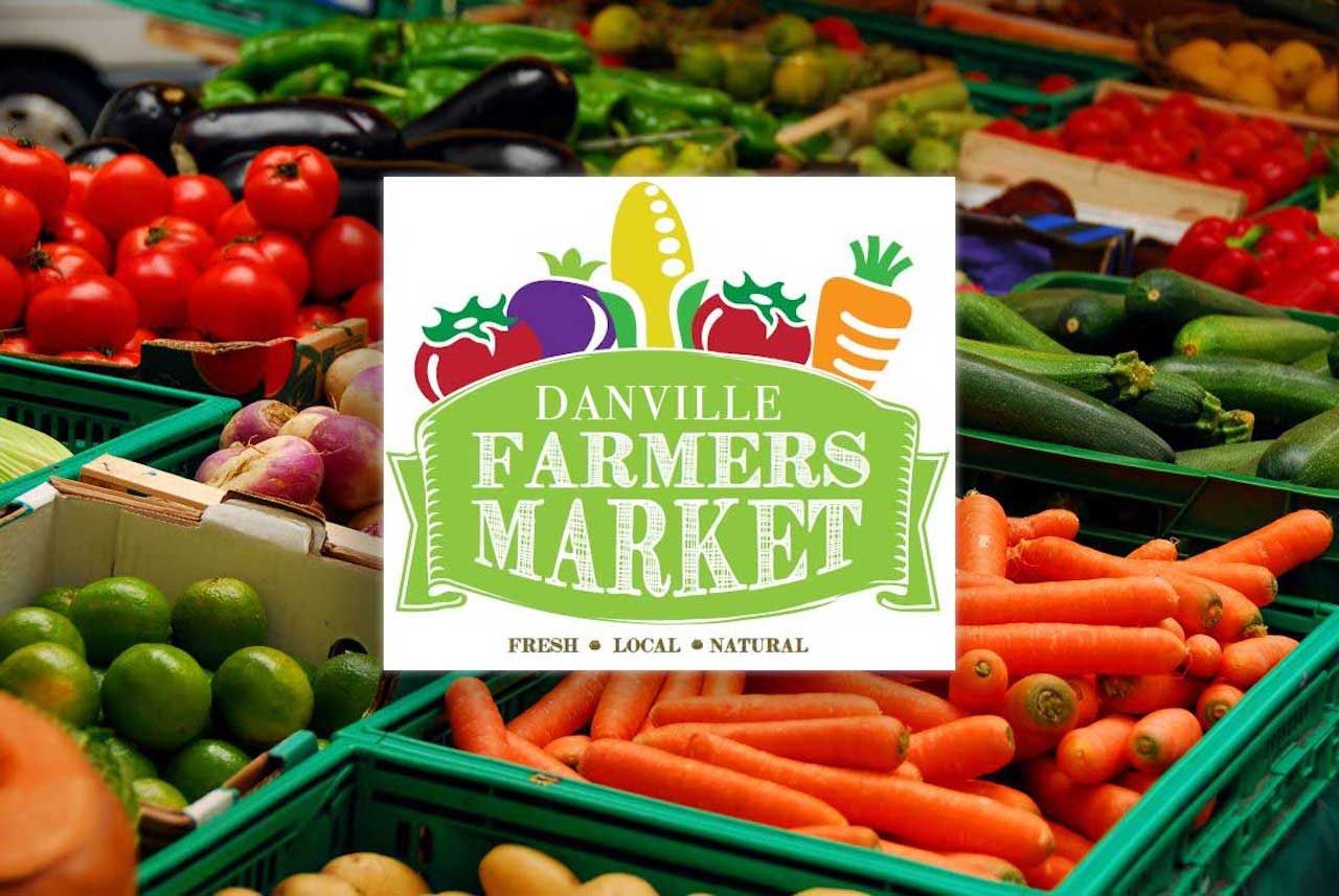A sign for danville farmers market with a bunch of vegetables