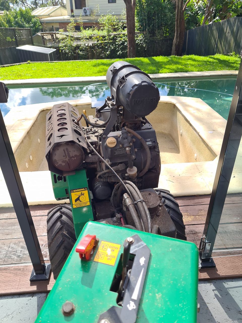 Green and Black Lawnmower on a Trailer — Lawn Care in Umina Beach, NSW