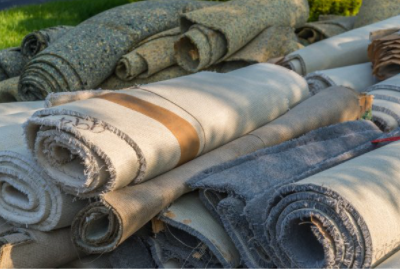 Carpet rolled up and is ready to be disposed of