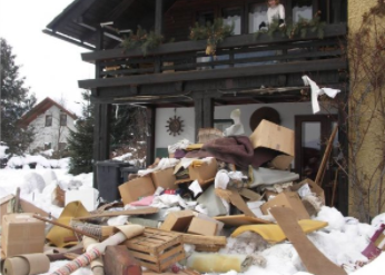 Junk in front of residential home that needs to be thrown in garbage
