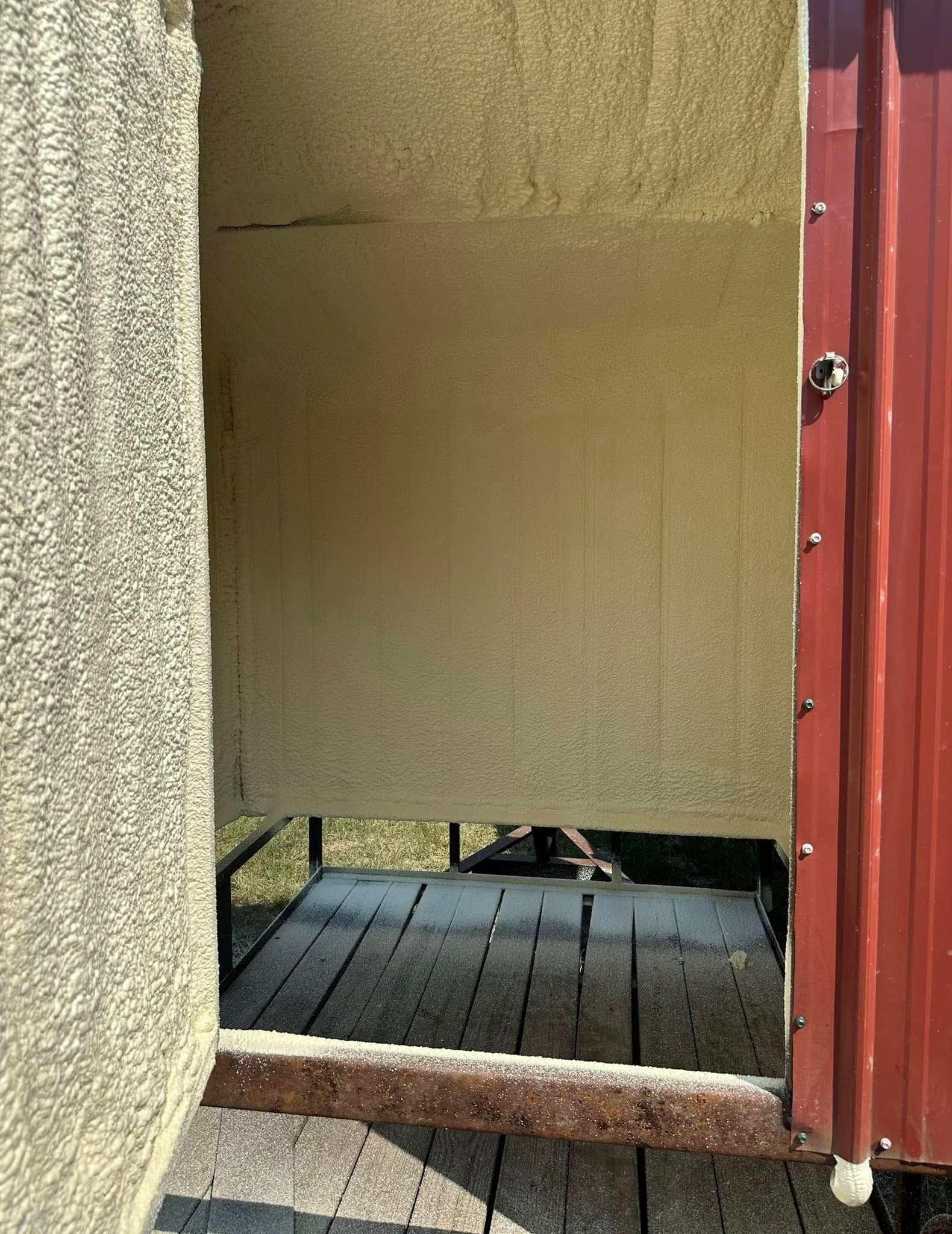 Partially open red door with a beige panel, showing a tiled floor inside and a textured wall outside