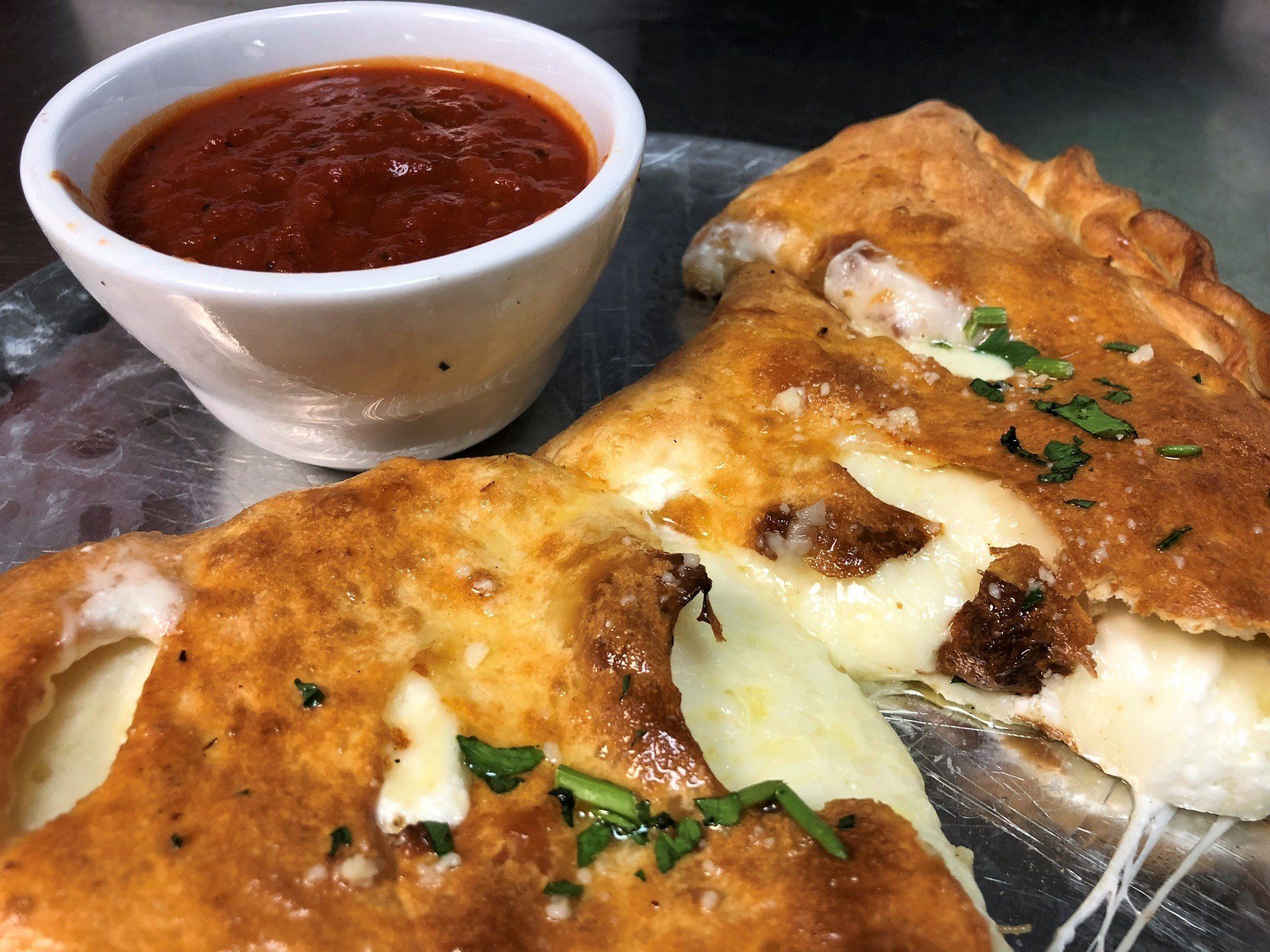 Big Louie’s Pizzeria calzone with gooey cheese and sauce