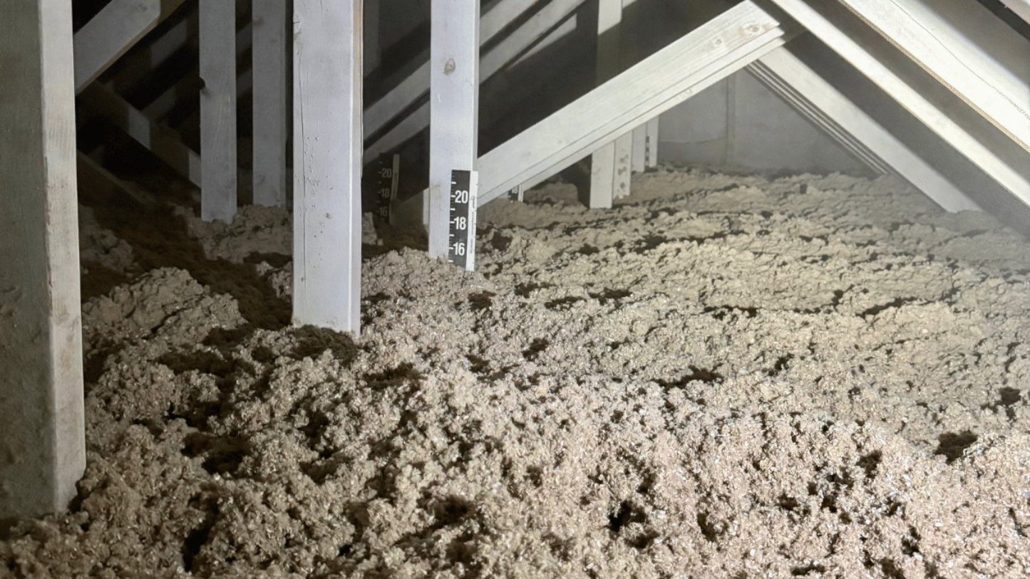 An attic filled with cellulose insulation to building code