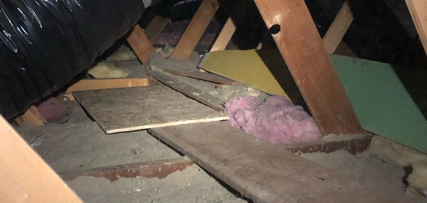 Old settled cellulose insulation before removal and replacement in Spokane attic