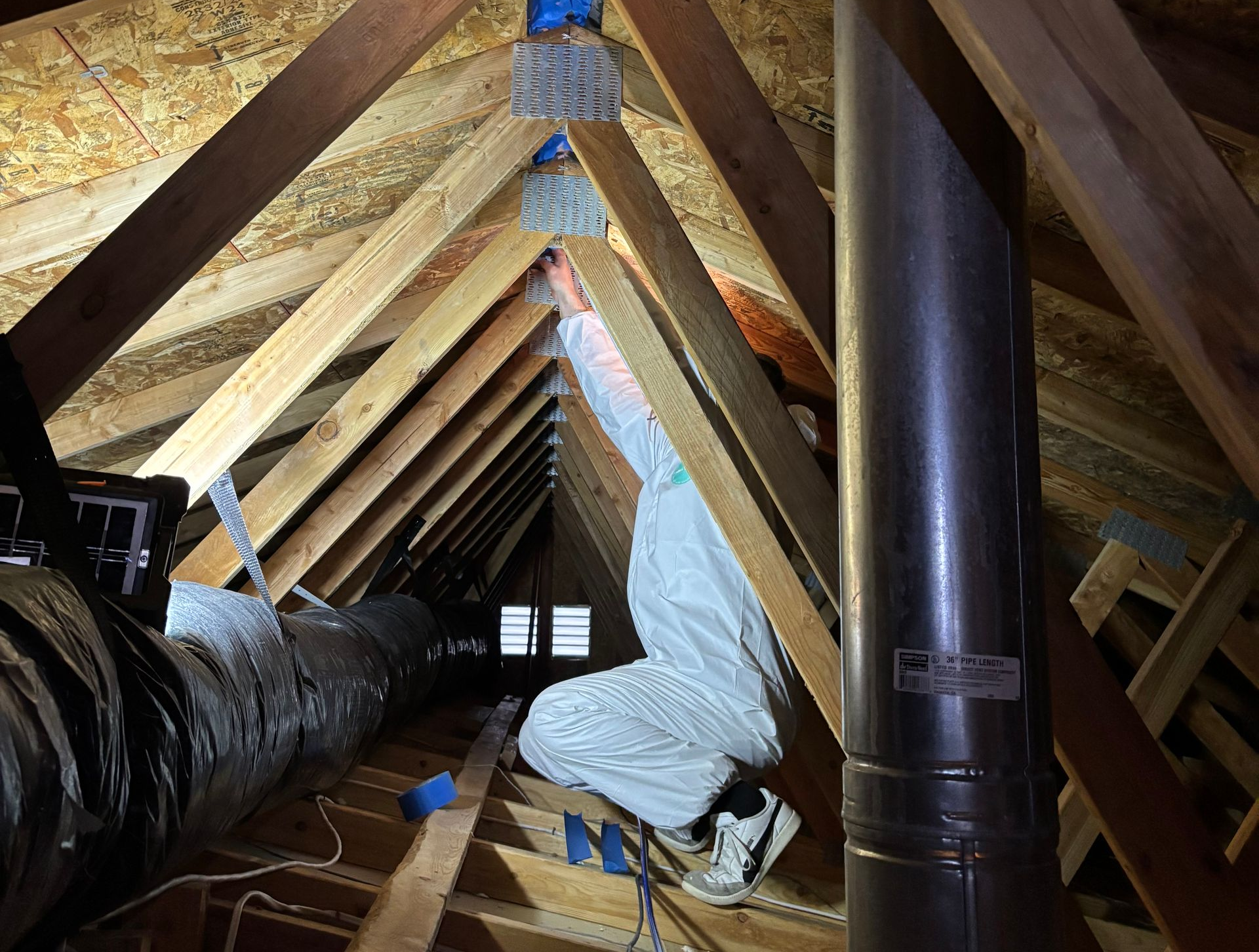 Pacific Insulation technician working in a Spokane attic