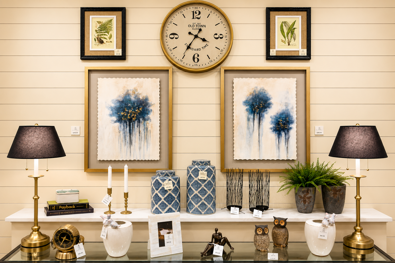 Elegant living room mantel with blue floral art, clock, lamps, and decorative vases