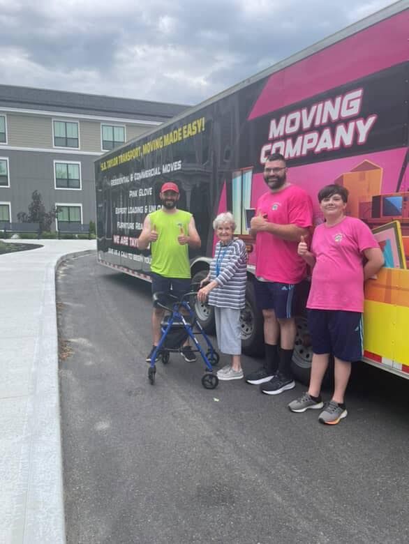 client standing beside truck with moving team